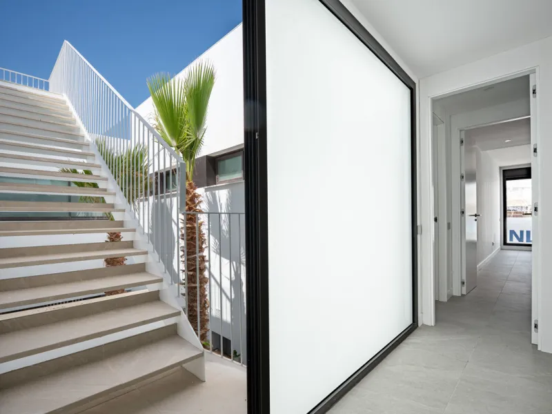 Penthouse Alma is a brand-new duplex home in a secure gated community in Marbella East. It has two ensuite bedrooms, a guest bathroom, and an open-plan living space that connects the kitchen, dining, and lounge areas. Floor-to-ceiling windows fill the hom