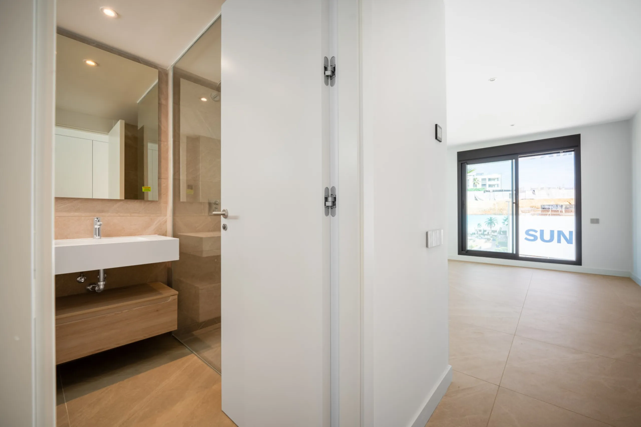 Penthouse Alma is a brand-new duplex home in a secure gated community in Marbella East. It has two ensuite bedrooms, a guest bathroom, and an open-plan living space that connects the kitchen, dining, and lounge areas. Floor-to-ceiling windows fill the hom