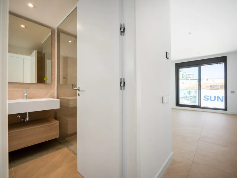 Penthouse Alma is a brand-new duplex home in a secure gated community in Marbella East. It has two ensuite bedrooms, a guest bathroom, and an open-plan living space that connects the kitchen, dining, and lounge areas. Floor-to-ceiling windows fill the hom
