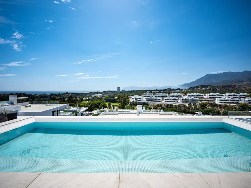 Penthouse Alma is a brand-new duplex home in a secure gated community in Marbella East. It has two ensuite bedrooms, a guest bathroom, and an open-plan living space that connects the kitchen, dining, and lounge areas. Floor-to-ceiling windows fill the hom