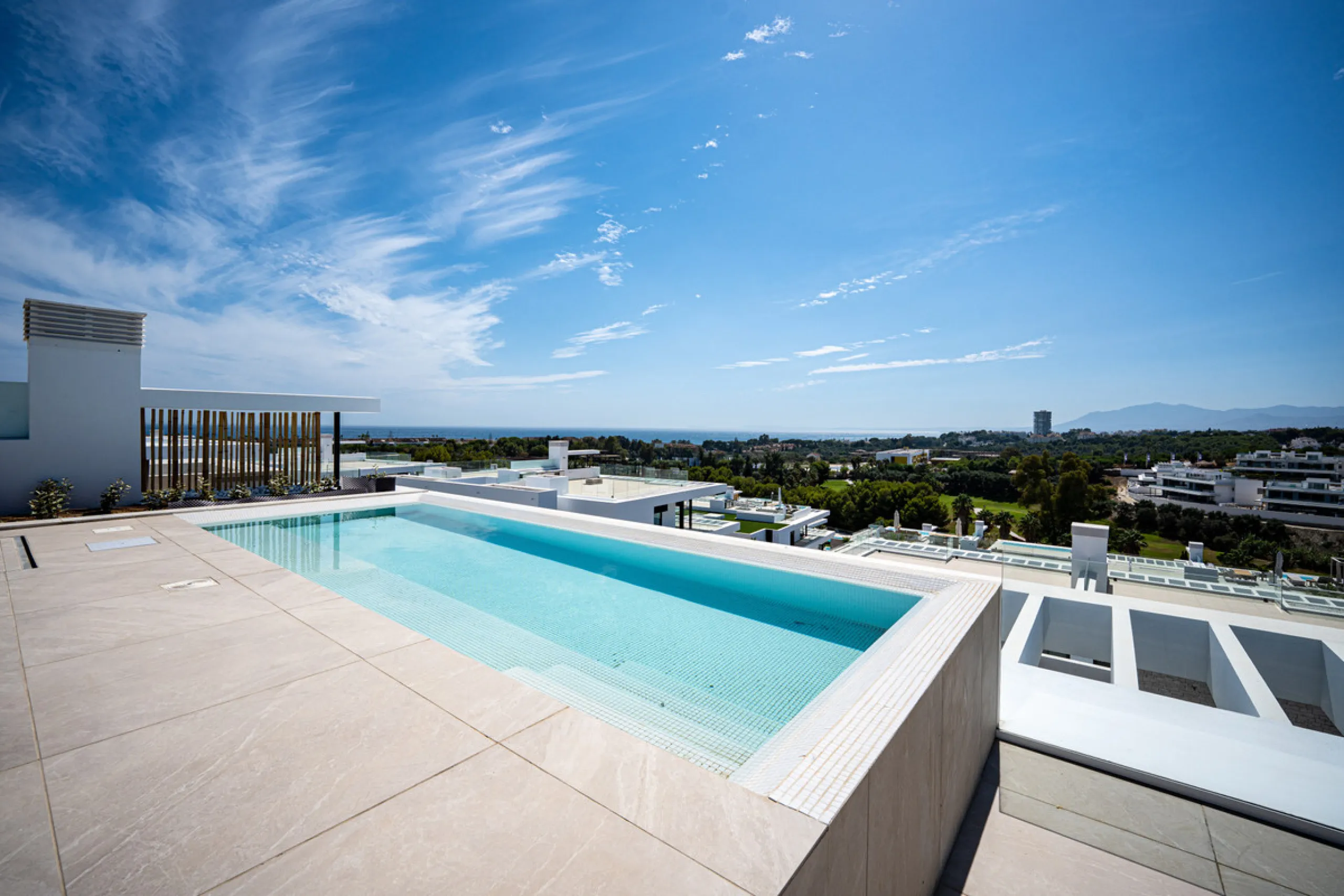 Penthouse Alma is a brand-new duplex home in a secure gated community in Marbella East. It has two ensuite bedrooms, a guest bathroom, and an open-plan living space that connects the kitchen, dining, and lounge areas. Floor-to-ceiling windows fill the hom