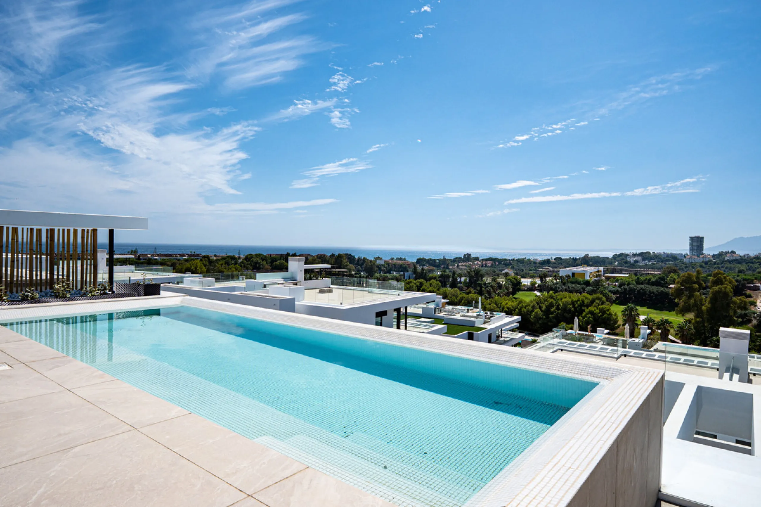 Penthouse Alma is a brand-new duplex home in a secure gated community in Marbella East. It has two ensuite bedrooms, a guest bathroom, and an open-plan living space that connects the kitchen, dining, and lounge areas. Floor-to-ceiling windows fill the hom