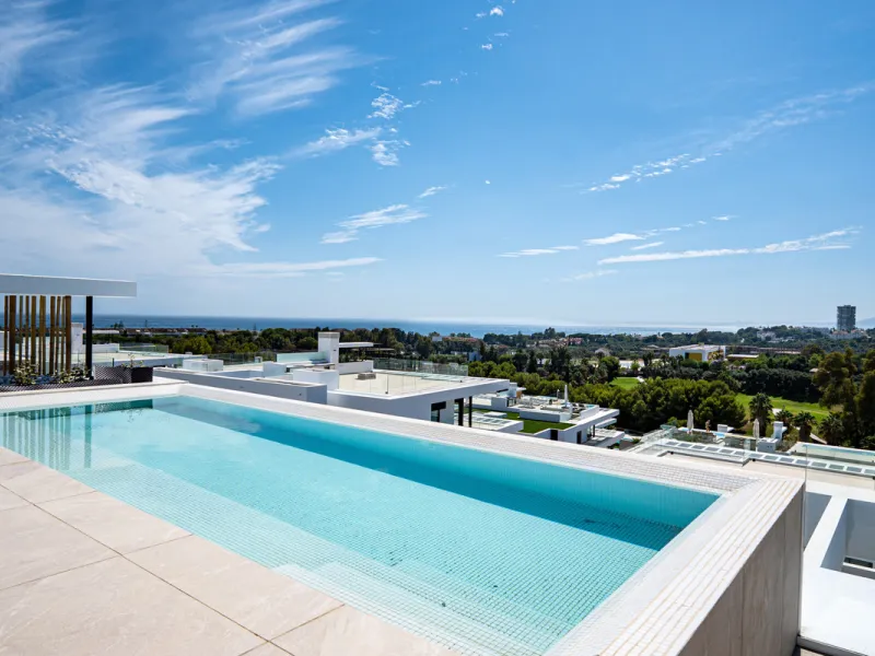 Penthouse Alma is a brand-new duplex home in a secure gated community in Marbella East. It has two ensuite bedrooms, a guest bathroom, and an open-plan living space that connects the kitchen, dining, and lounge areas. Floor-to-ceiling windows fill the hom