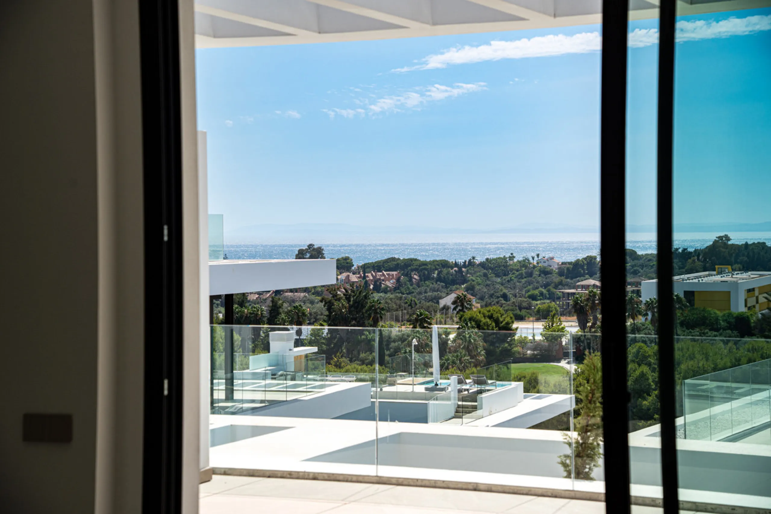 Penthouse Alma is a brand-new duplex home in a secure gated community in Marbella East. It has two ensuite bedrooms, a guest bathroom, and an open-plan living space that connects the kitchen, dining, and lounge areas. Floor-to-ceiling windows fill the hom