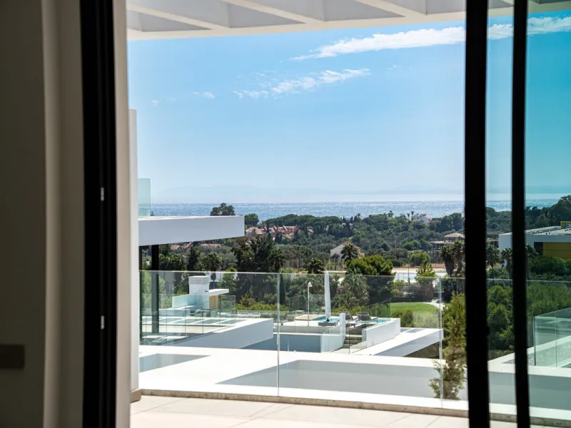 Penthouse Alma is a brand-new duplex home in a secure gated community in Marbella East. It has two ensuite bedrooms, a guest bathroom, and an open-plan living space that connects the kitchen, dining, and lounge areas. Floor-to-ceiling windows fill the hom