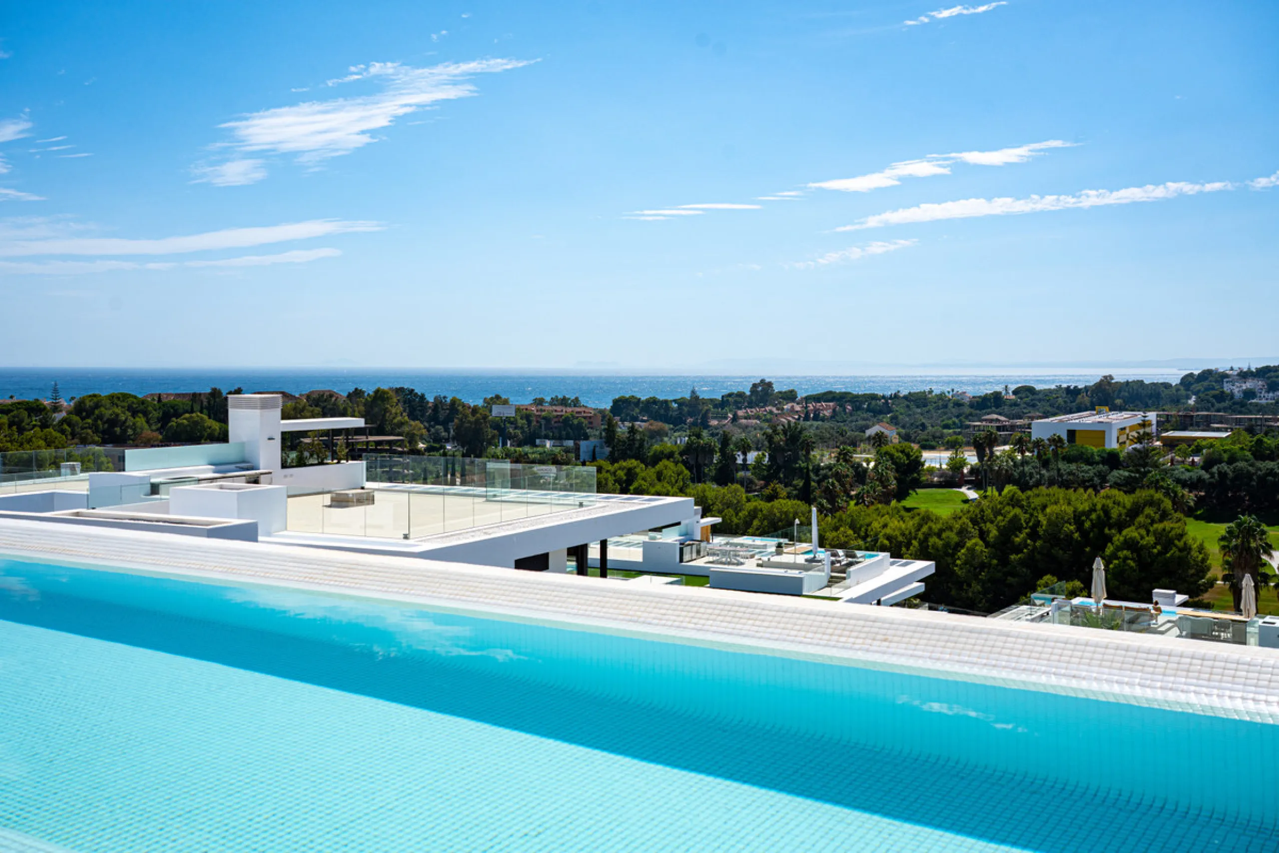 Penthouse Alma is a brand-new duplex home in a secure gated community in Marbella East. It has two ensuite bedrooms, a guest bathroom, and an open-plan living space that connects the kitchen, dining, and lounge areas. Floor-to-ceiling windows fill the hom