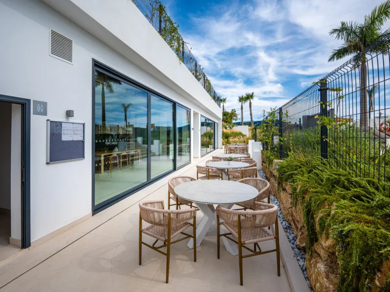 Penthouse Alma is a brand-new duplex home in a secure gated community in Marbella East. It has two ensuite bedrooms, a guest bathroom, and an open-plan living space that connects the kitchen, dining, and lounge areas. Floor-to-ceiling windows fill the hom