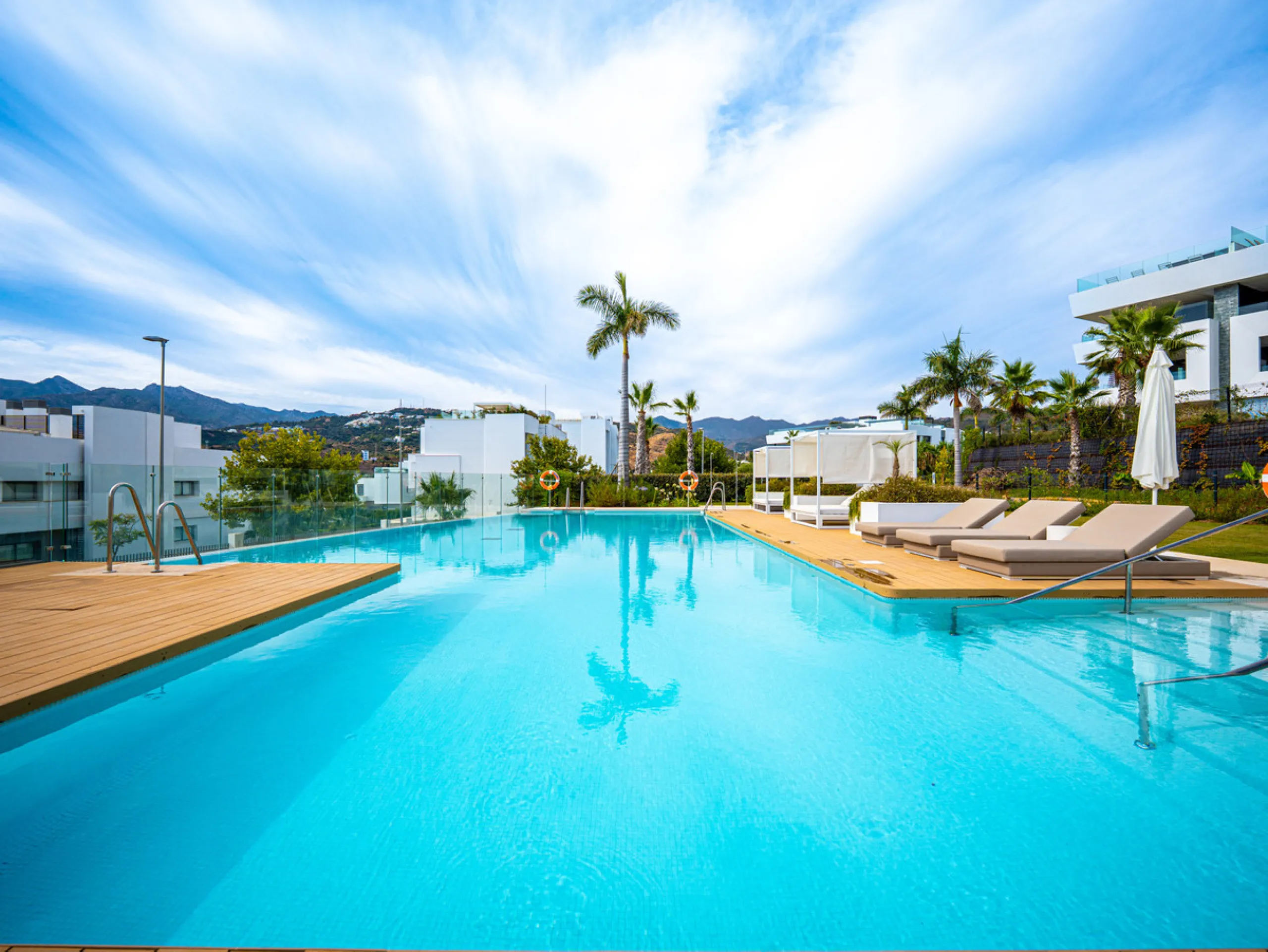 Penthouse Alma is a brand-new duplex home in a secure gated community in Marbella East. It has two ensuite bedrooms, a guest bathroom, and an open-plan living space that connects the kitchen, dining, and lounge areas. Floor-to-ceiling windows fill the hom