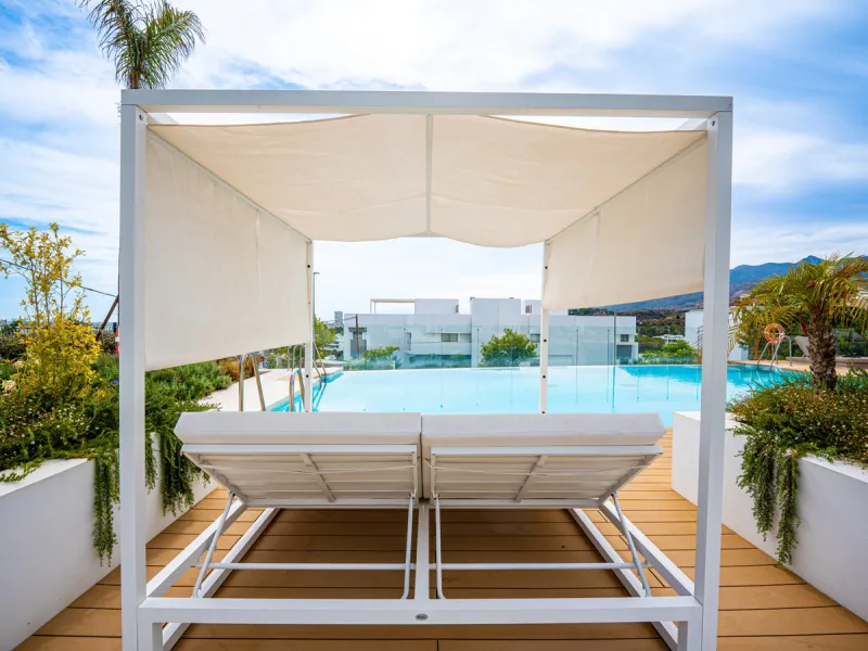 Penthouse Alma is a brand-new duplex home in a secure gated community in Marbella East. It has two ensuite bedrooms, a guest bathroom, and an open-plan living space that connects the kitchen, dining, and lounge areas. Floor-to-ceiling windows fill the hom