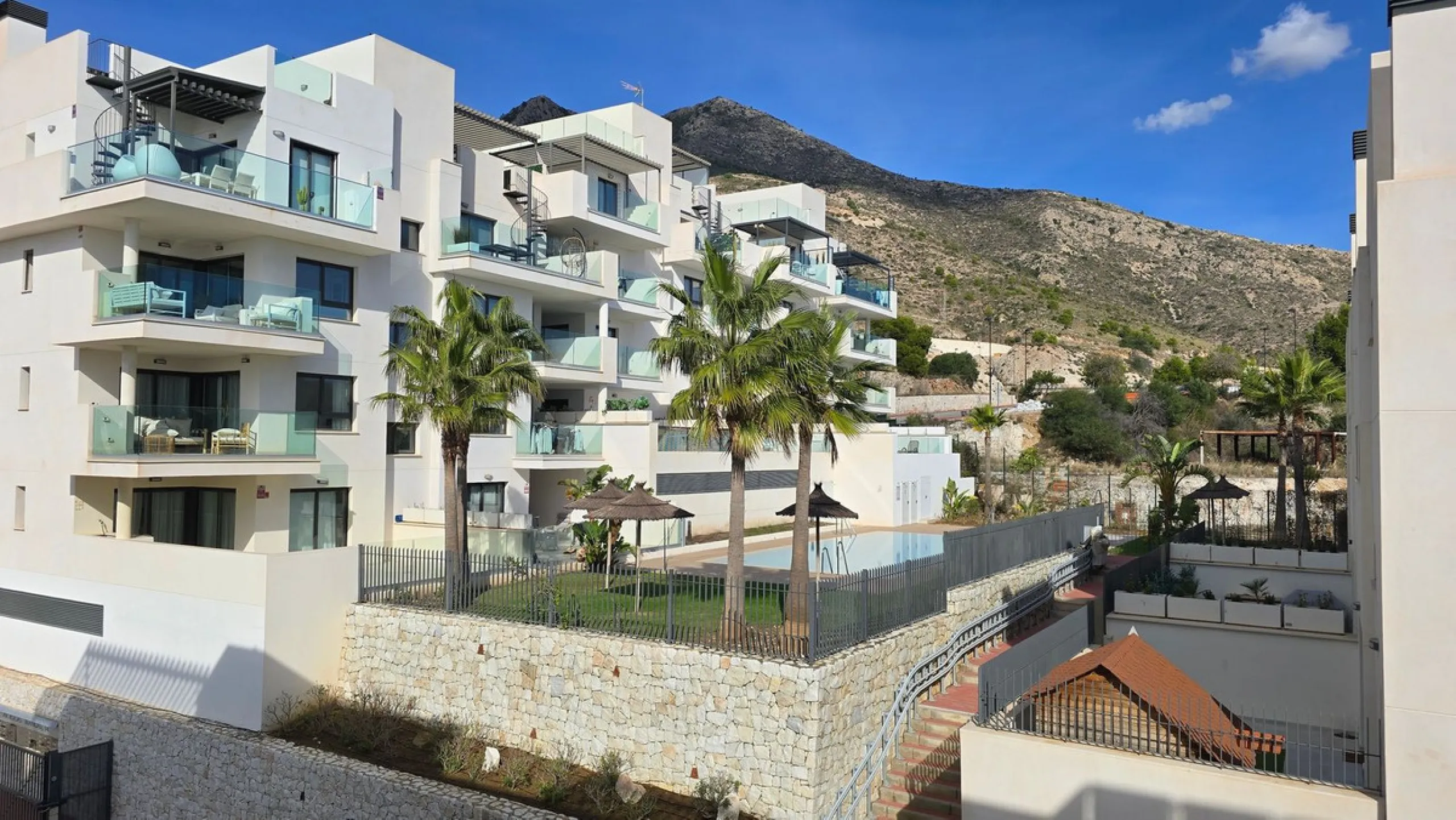This penthouse in Benalmadena is listed at €545,000 and offers 84 m² of interior living space with two bedrooms, two bathrooms, direct access to a 71 m² total terrace area including a private rooftop solarium, plus two parking spaces and a storage room—al