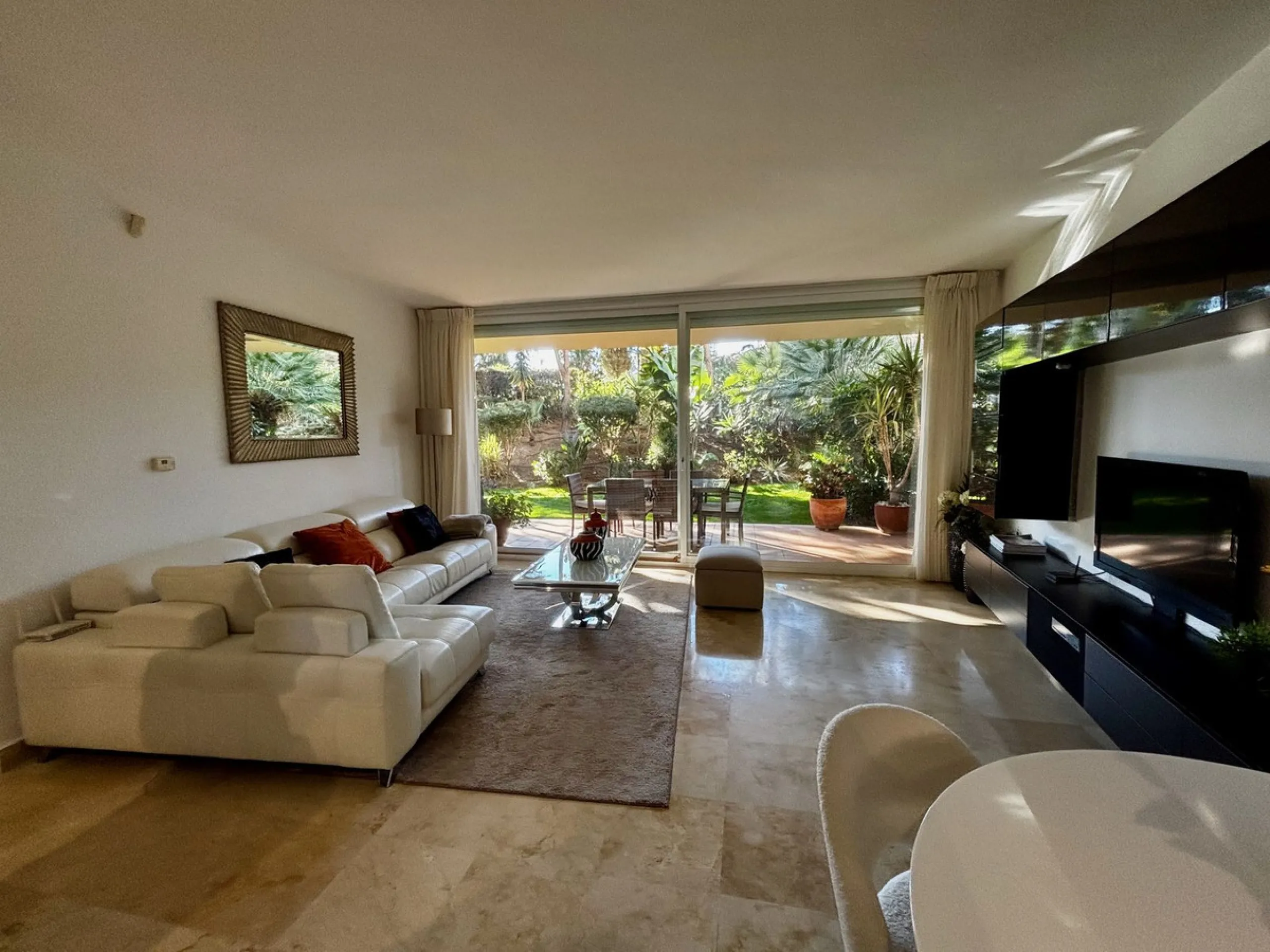 Discover this elegant 2-bedroom, 2-bathroom ground-floor apartment located in the sought-after Milenio complex in Miraflores, perfectly positioned front line to the golf course. This charming home combines comfort, style, and resort-like amenities—ideal f