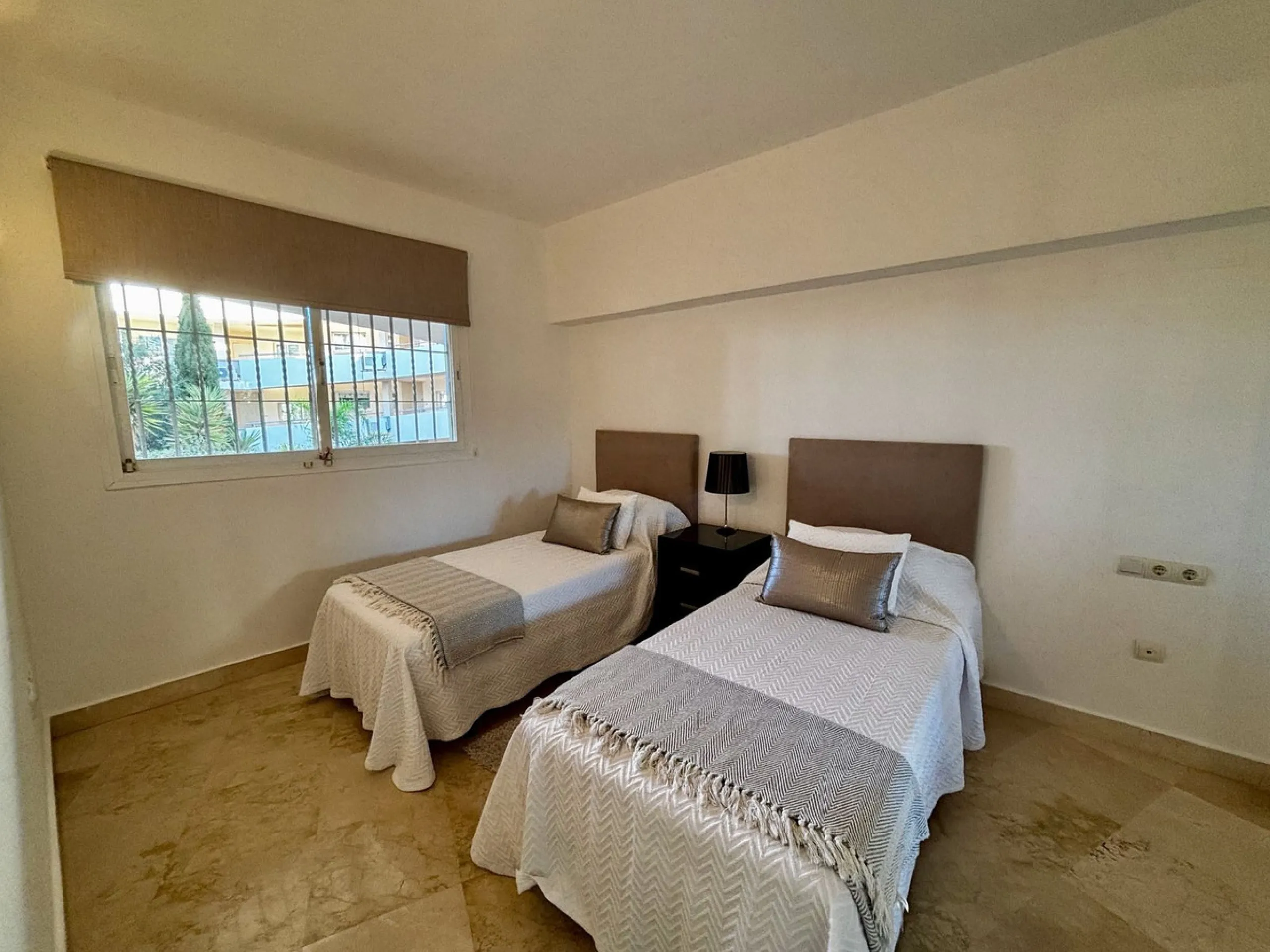 Discover this elegant 2-bedroom, 2-bathroom ground-floor apartment located in the sought-after Milenio complex in Miraflores, perfectly positioned front line to the golf course. This charming home combines comfort, style, and resort-like amenities—ideal f