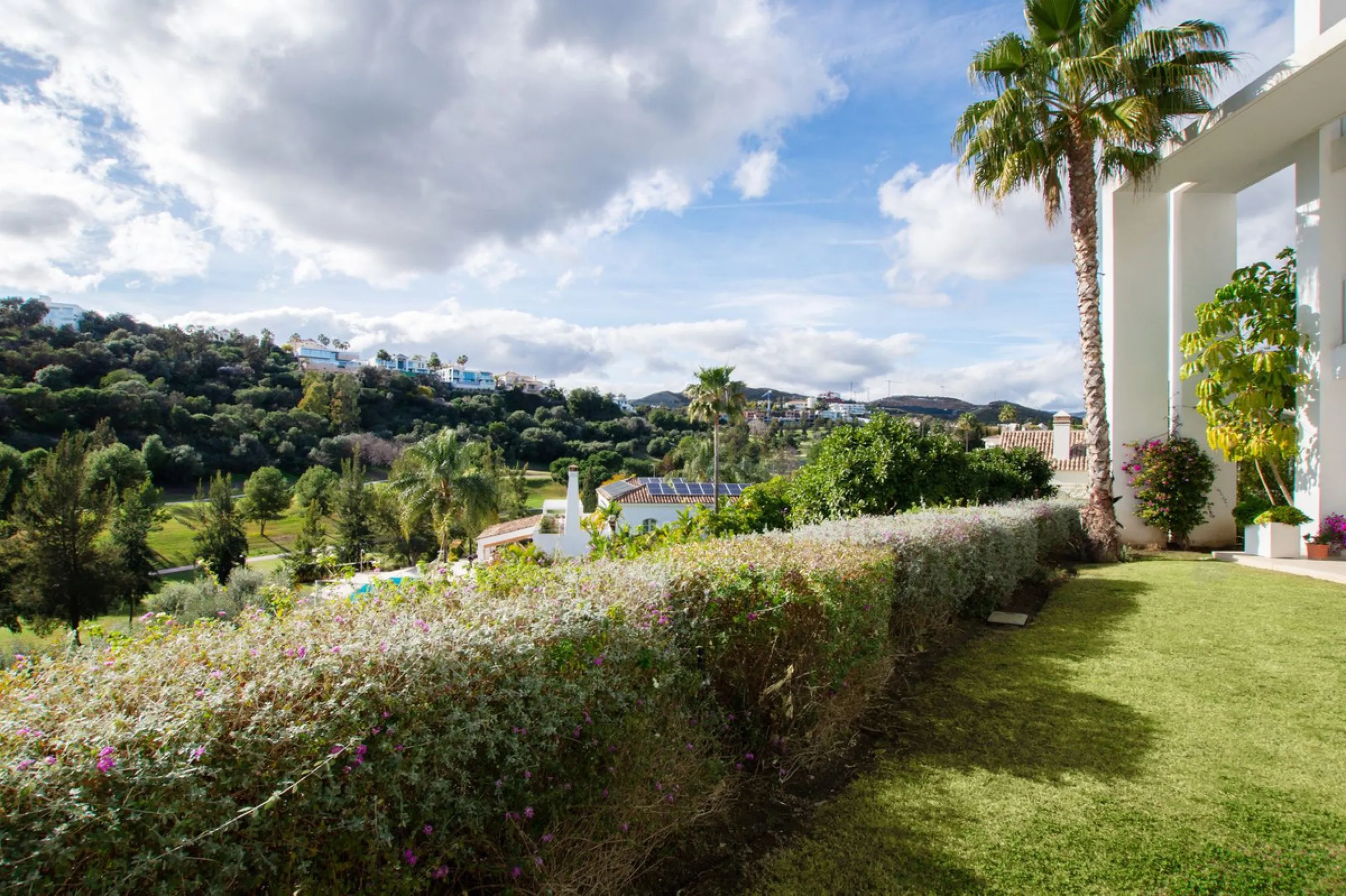 Discover the perfect blend of modern luxury and tranquility in this beautifully renovated 3-bedroom ground-floor apartment located in the prestigious Atalaya Hills. Offering breathtaking views over lush gardens, this stunning corner unit provides exceptio
