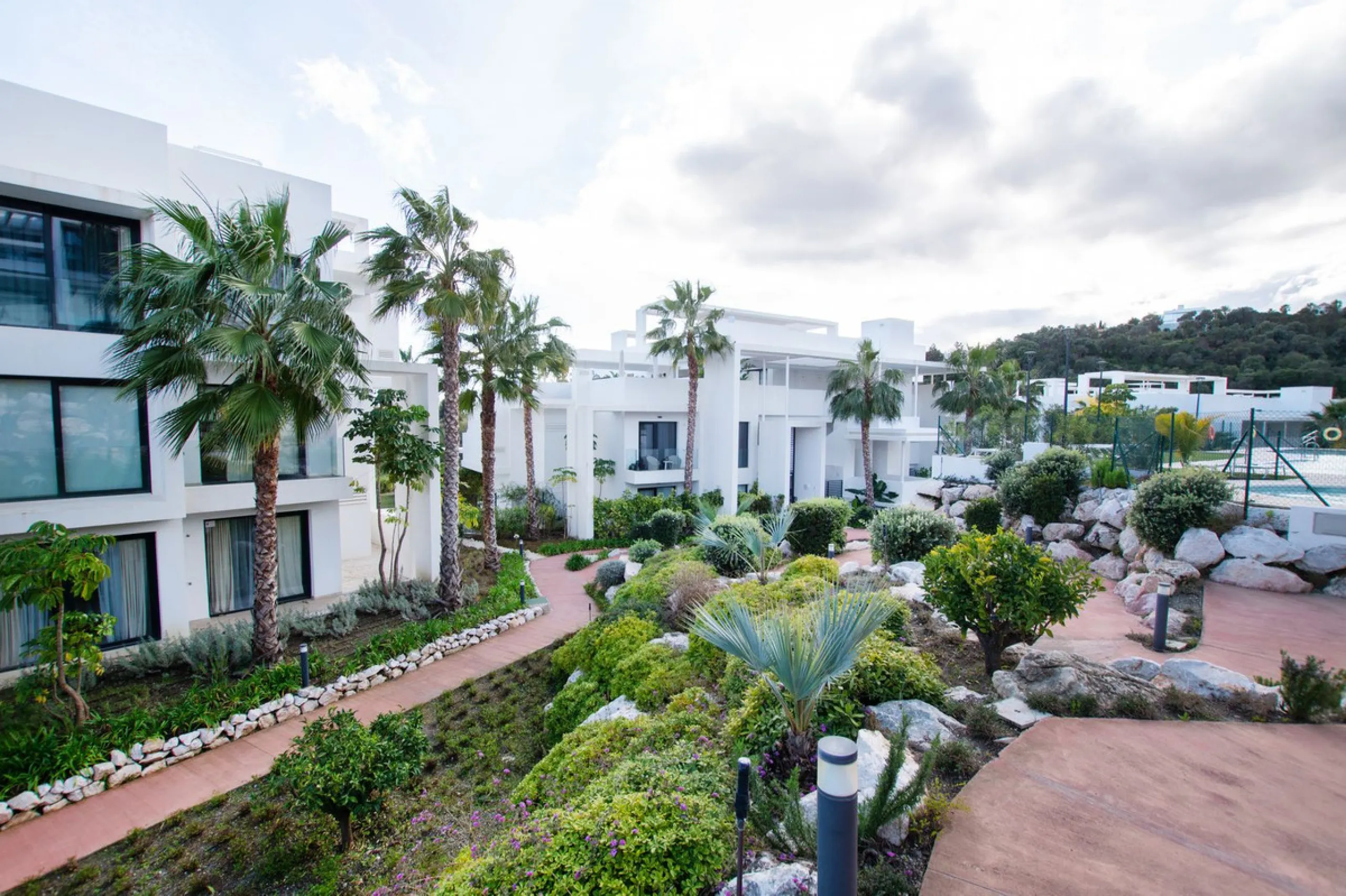 Discover the perfect blend of modern luxury and tranquility in this beautifully renovated 3-bedroom ground-floor apartment located in the prestigious Atalaya Hills. Offering breathtaking views over lush gardens, this stunning corner unit provides exceptio