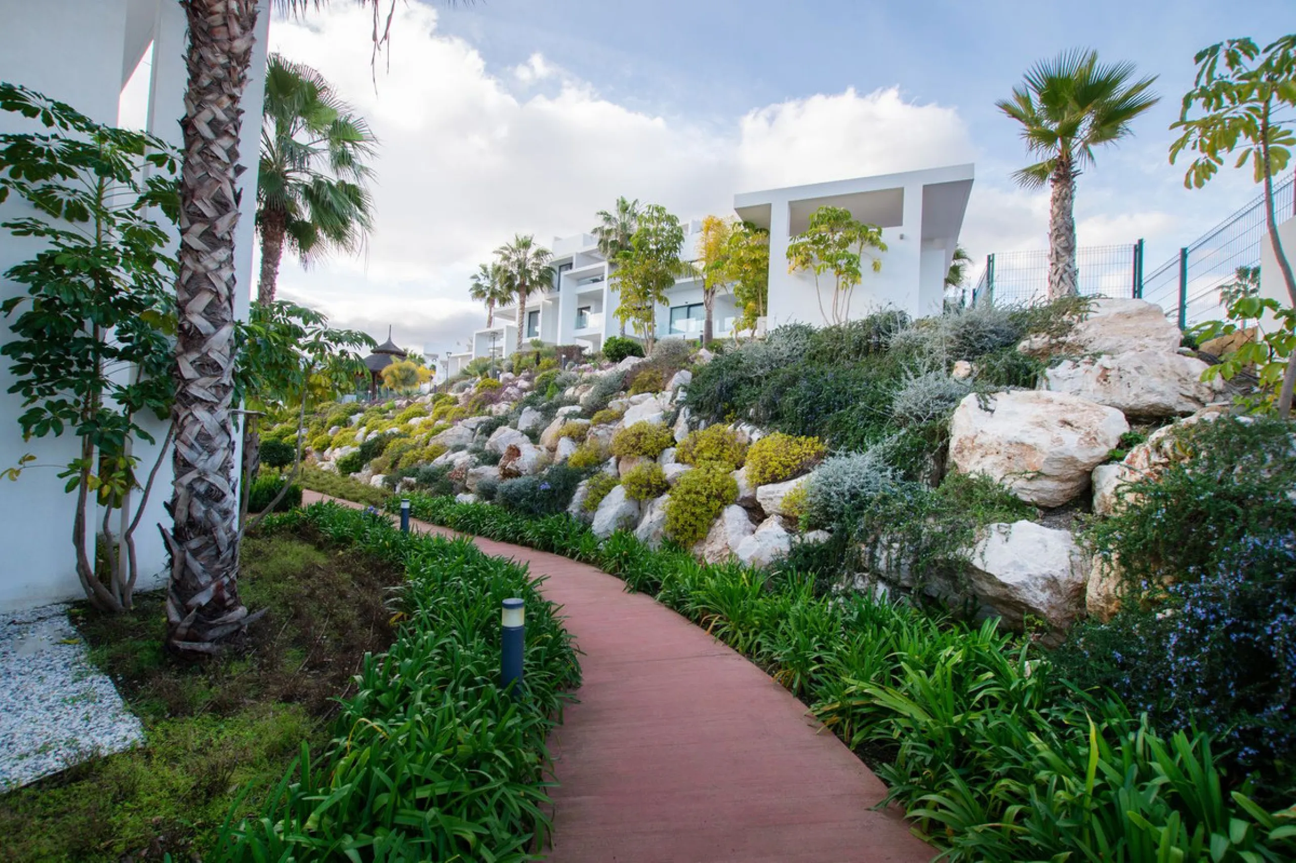Discover the perfect blend of modern luxury and tranquility in this beautifully renovated 3-bedroom ground-floor apartment located in the prestigious Atalaya Hills. Offering breathtaking views over lush gardens, this stunning corner unit provides exceptio