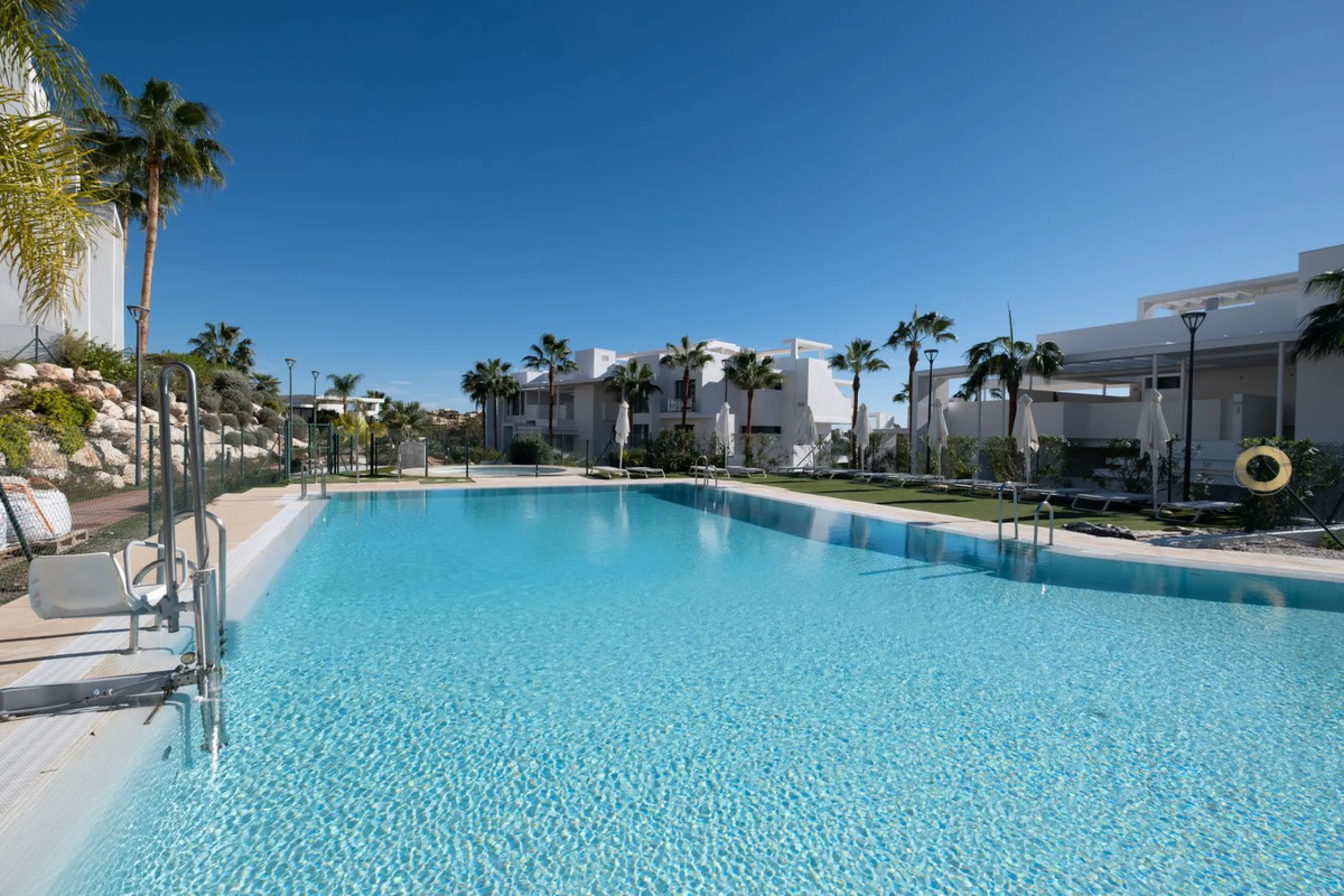 Discover the perfect blend of modern luxury and tranquility in this beautifully renovated 3-bedroom ground-floor apartment located in the prestigious Atalaya Hills. Offering breathtaking views over lush gardens, this stunning corner unit provides exceptio