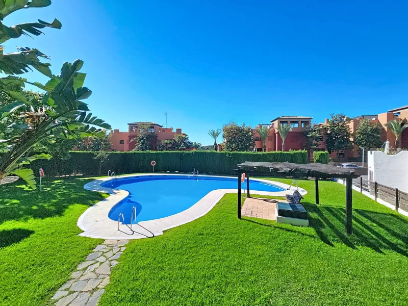 Welcome to this well-maintained two-bedroom, two-bathroom apartment set within the quiet and secure Casares Golf & Country Club, just minutes from the beach and the renowned Finca Cortesín resort.