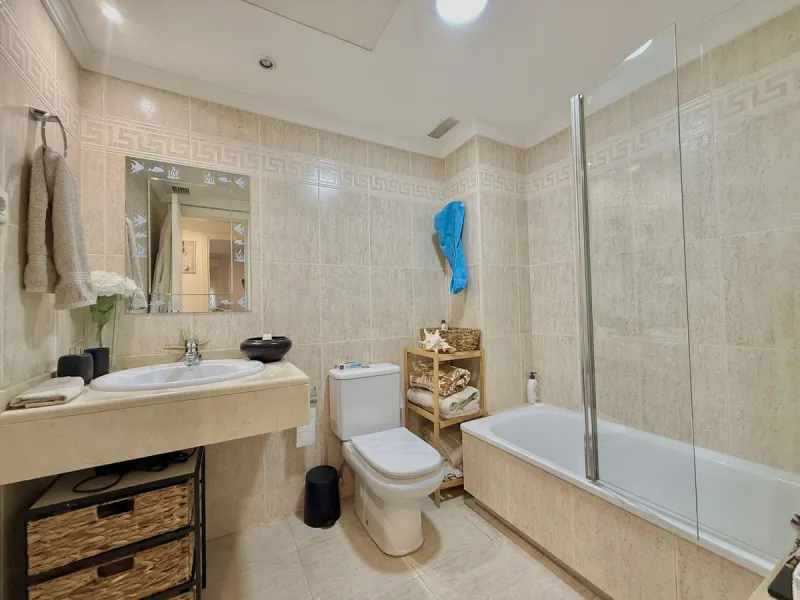 Located in a prestigious urbanization in Nagüeles, within the exclusive neighborhood of La Carolina, Guadalpin, Marbella, this property offers a unique lifestyle. The layout includes an entrance hall that leads to two bedrooms, two bathrooms, a spacious l