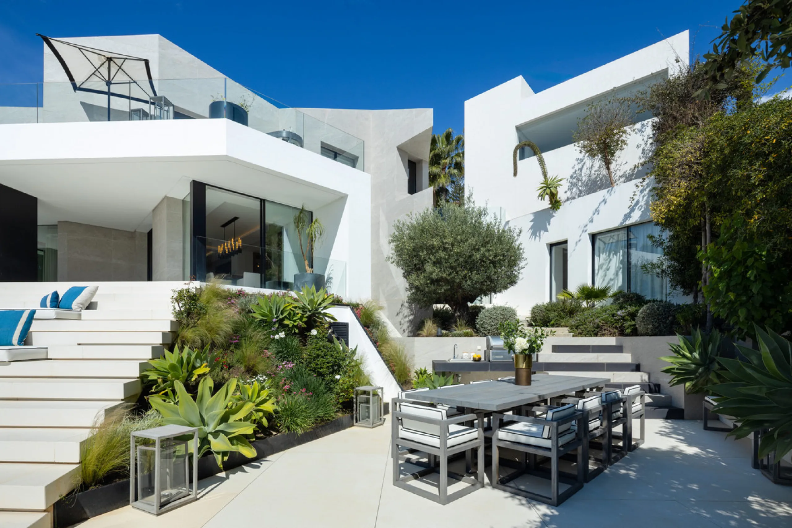 This is a contemporary 5-bedroom luxury villa for sale in the prestigious La Quinta Golf Resort, Benahavís, offering panoramic views and exceptional modern living in one of the Costa del Sol's most desirable gated communities.