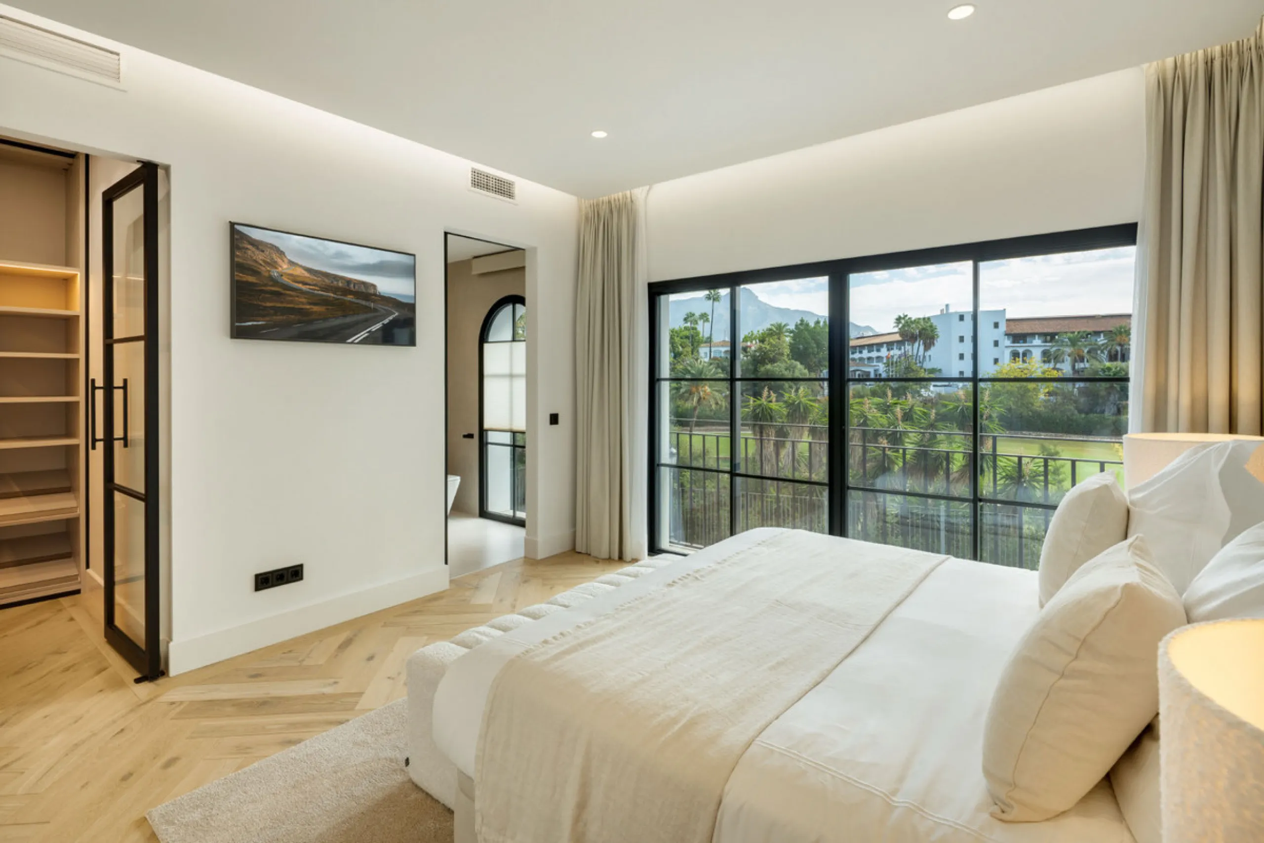 Exceptional villa for sale in the prestigious gated community of El Herrojo Alto, one of La Quinta's most sought-after residential areas. Positioned on an elevated frontline golf plot, this landmark property harmoniously blends timeless Andalusian archite