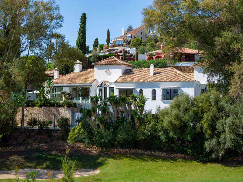 Exceptional villa for sale in the prestigious gated community of El Herrojo Alto, one of La Quinta's most sought-after residential areas. Positioned on an elevated frontline golf plot, this landmark property harmoniously blends timeless Andalusian archite