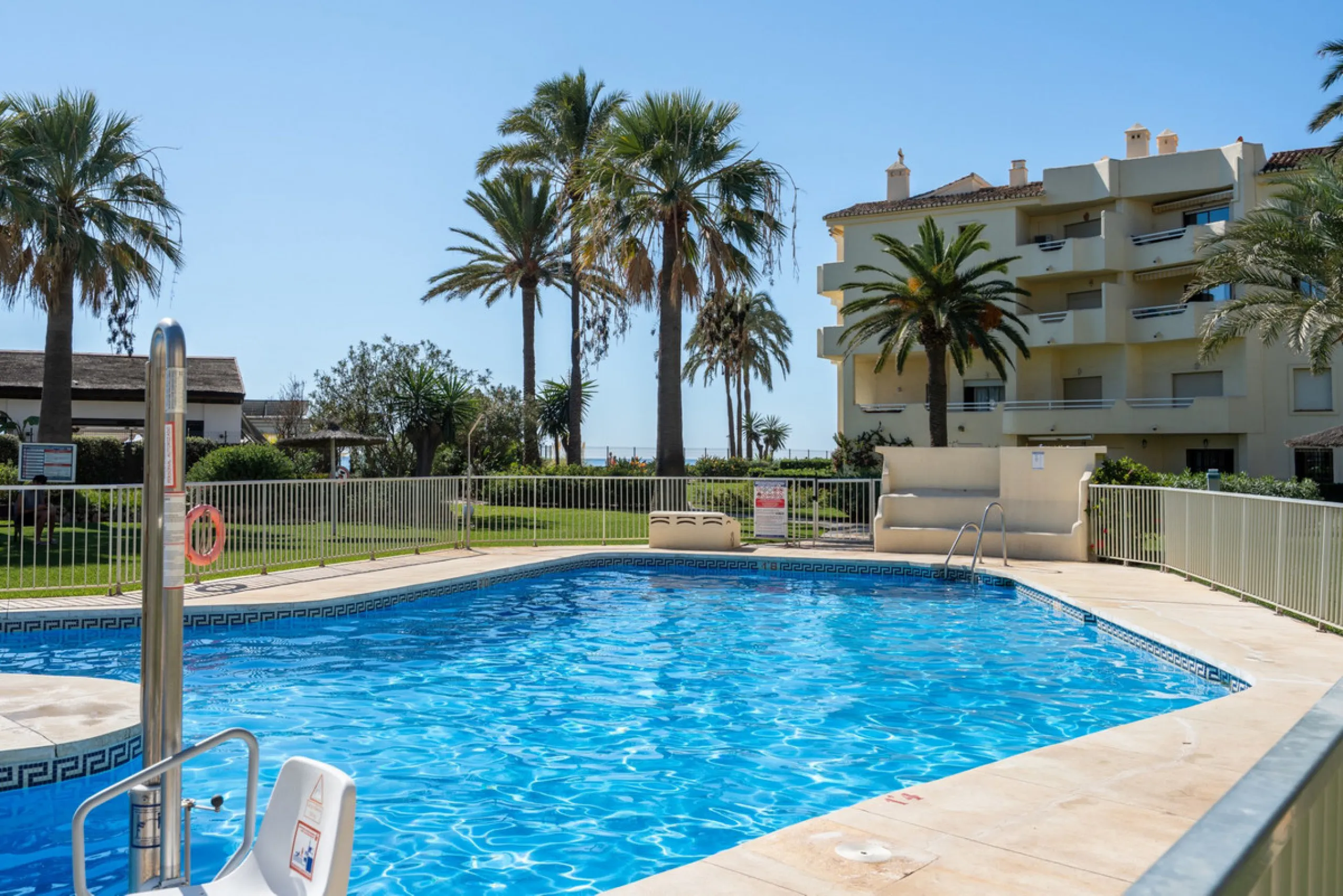 This apartment is situated in a prestigious, gated first-line beach community with extensive, beautifully maintained gardens. It enjoys lovely views of the sea and the surrounding greenery. The south-facing orientation provides plenty of natural light, an