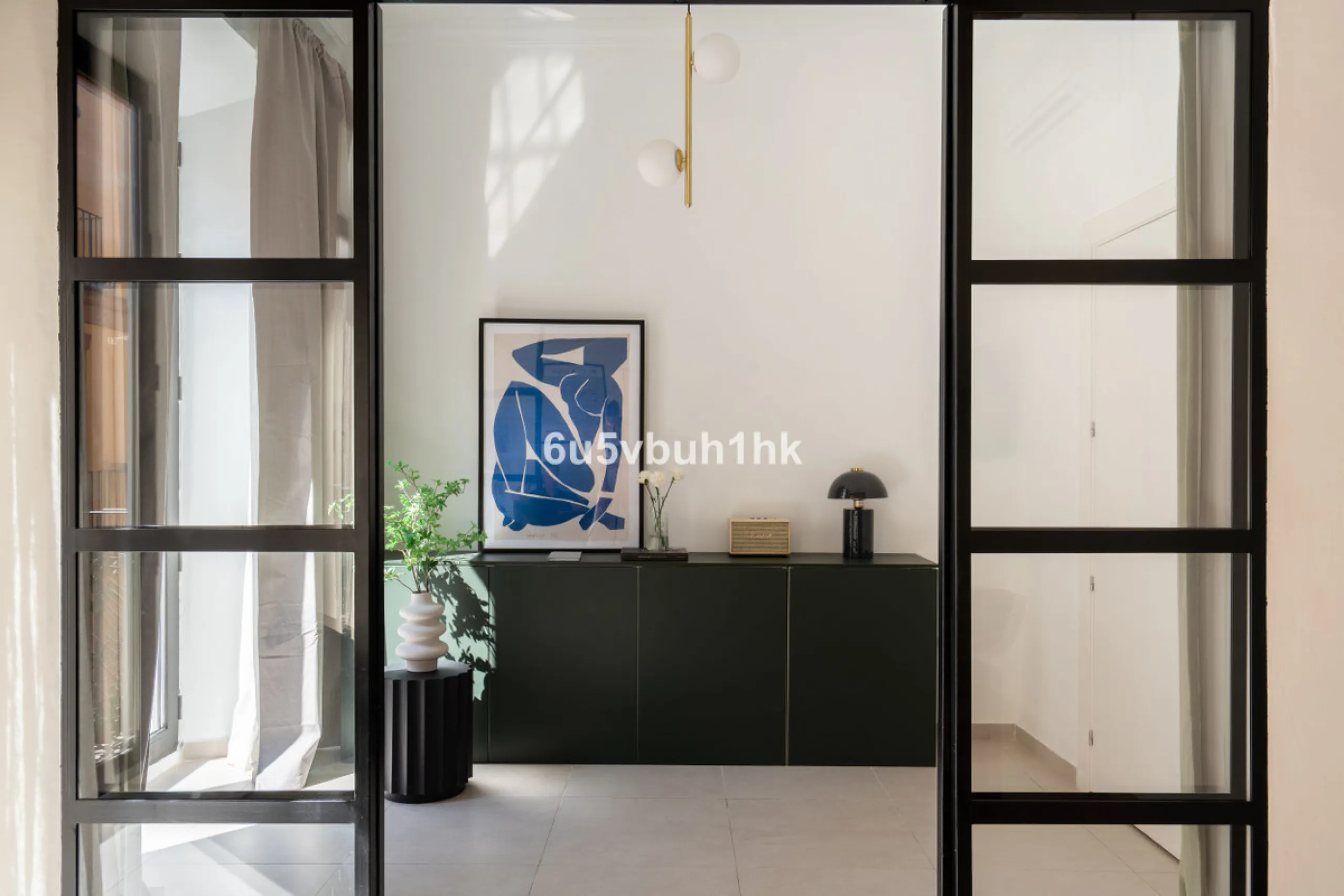 Imagine living in Málaga's historic center, on a wide and quiet street just a stone's throw from Calle Carretería. This apartment has something rare—a feeling of space, privacy, and uplifting light that fills every room. Step out onto any of the three sun
