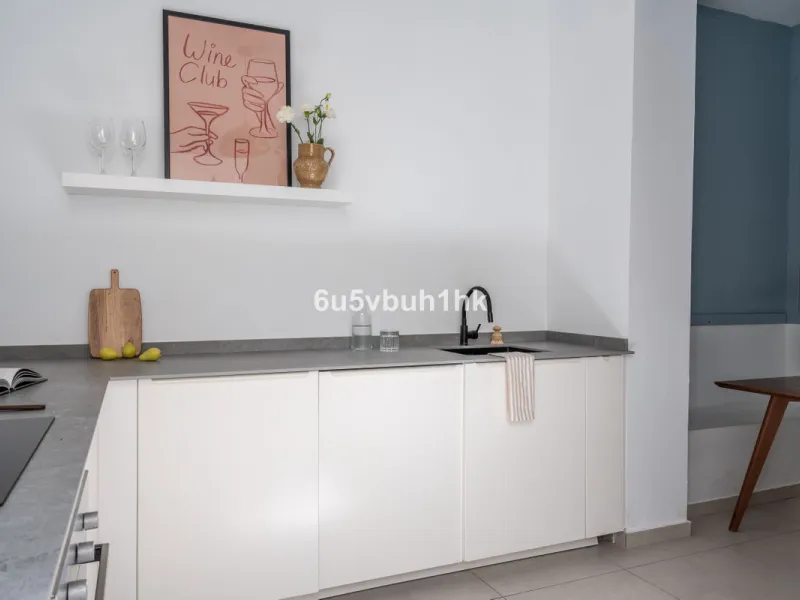 Imagine living in Málaga's historic center, on a wide and quiet street just a stone's throw from Calle Carretería. This apartment has something rare—a feeling of space, privacy, and uplifting light that fills every room. Step out onto any of the three sun