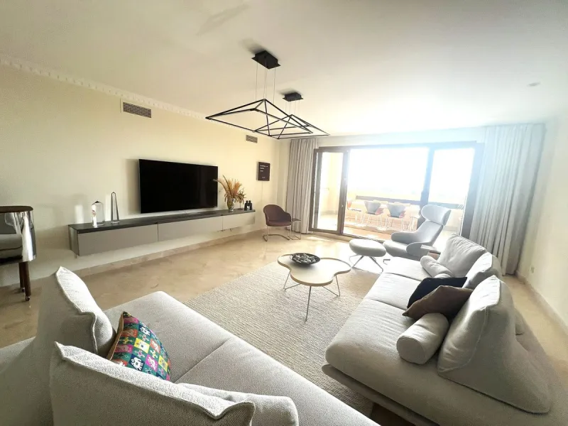 Discover this exceptional first-floor corner apartment, where modern comfort meets breathtaking scenery. Boasting two expansive, glassed in terraces, the residence offers panoramic views that stretch from the sparkling Mediterranean Sea to the majestic su