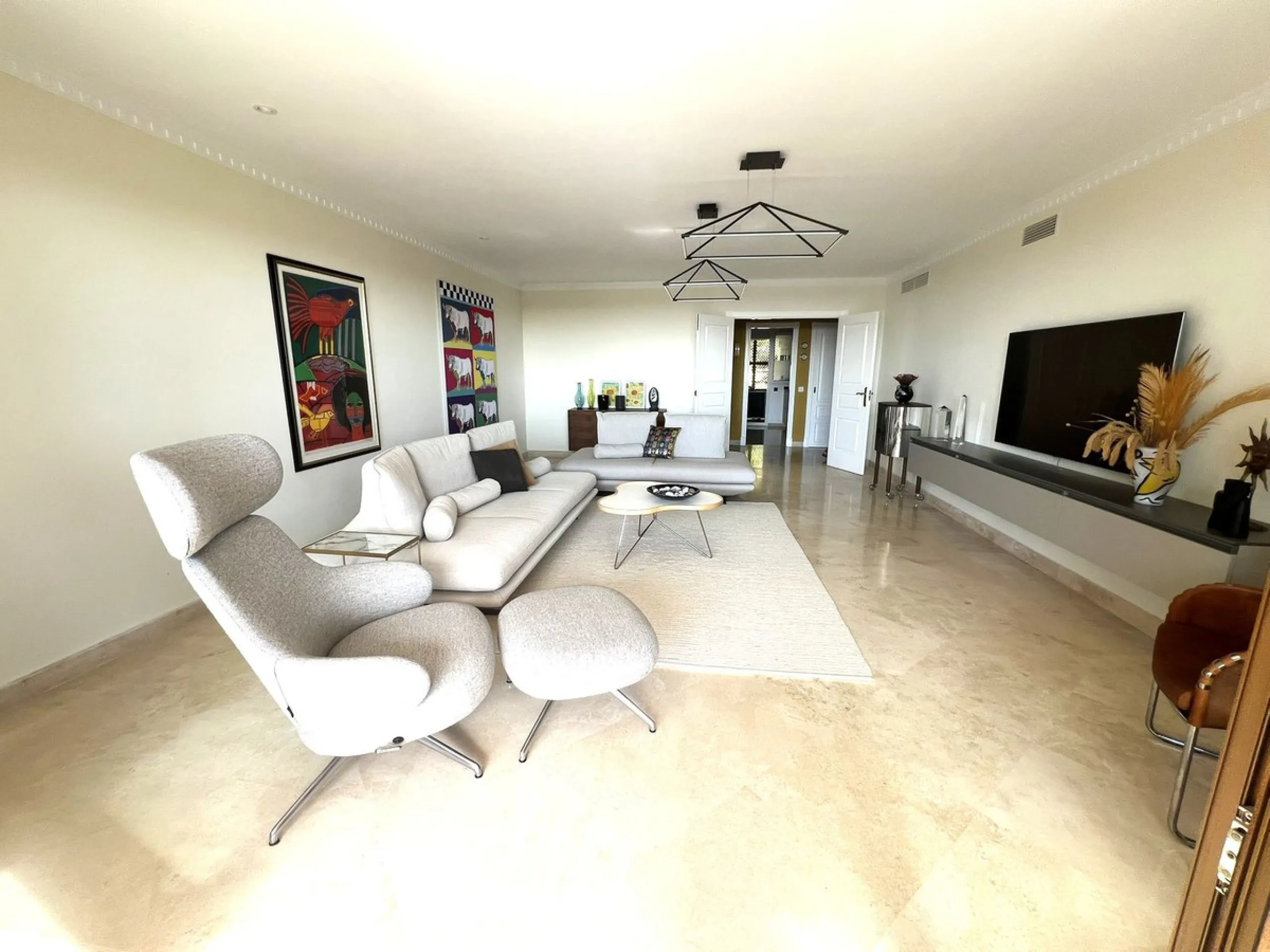 Discover this exceptional first-floor corner apartment, where modern comfort meets breathtaking scenery. Boasting two expansive, glassed in terraces, the residence offers panoramic views that stretch from the sparkling Mediterranean Sea to the majestic su
