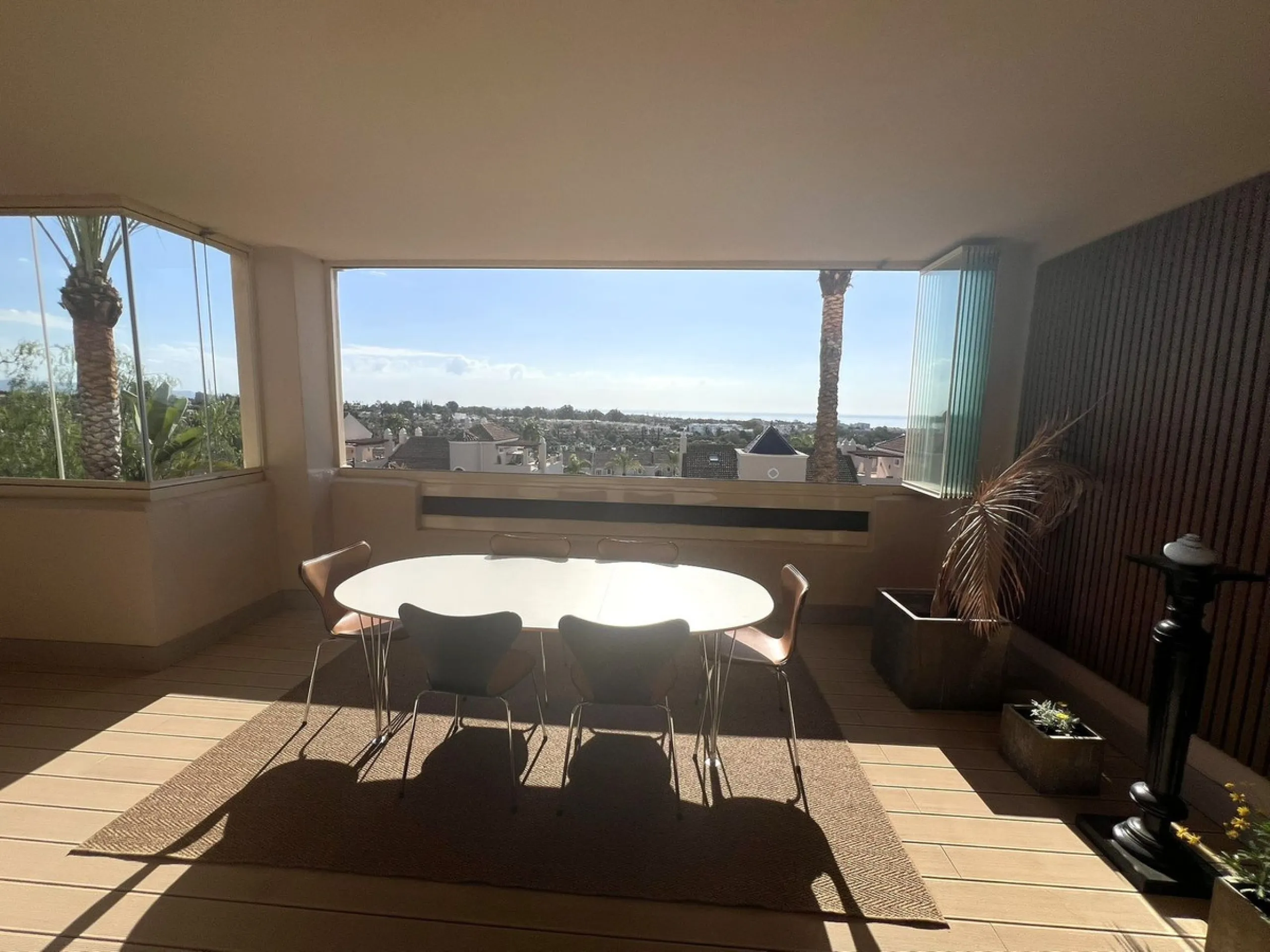 Discover this exceptional first-floor corner apartment, where modern comfort meets breathtaking scenery. Boasting two expansive, glassed in terraces, the residence offers panoramic views that stretch from the sparkling Mediterranean Sea to the majestic su