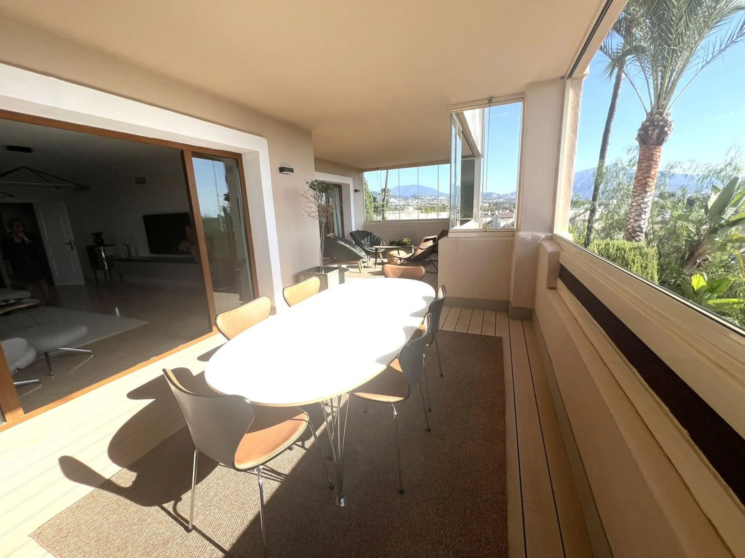 Discover this exceptional first-floor corner apartment, where modern comfort meets breathtaking scenery. Boasting two expansive, glassed in terraces, the residence offers panoramic views that stretch from the sparkling Mediterranean Sea to the majestic su