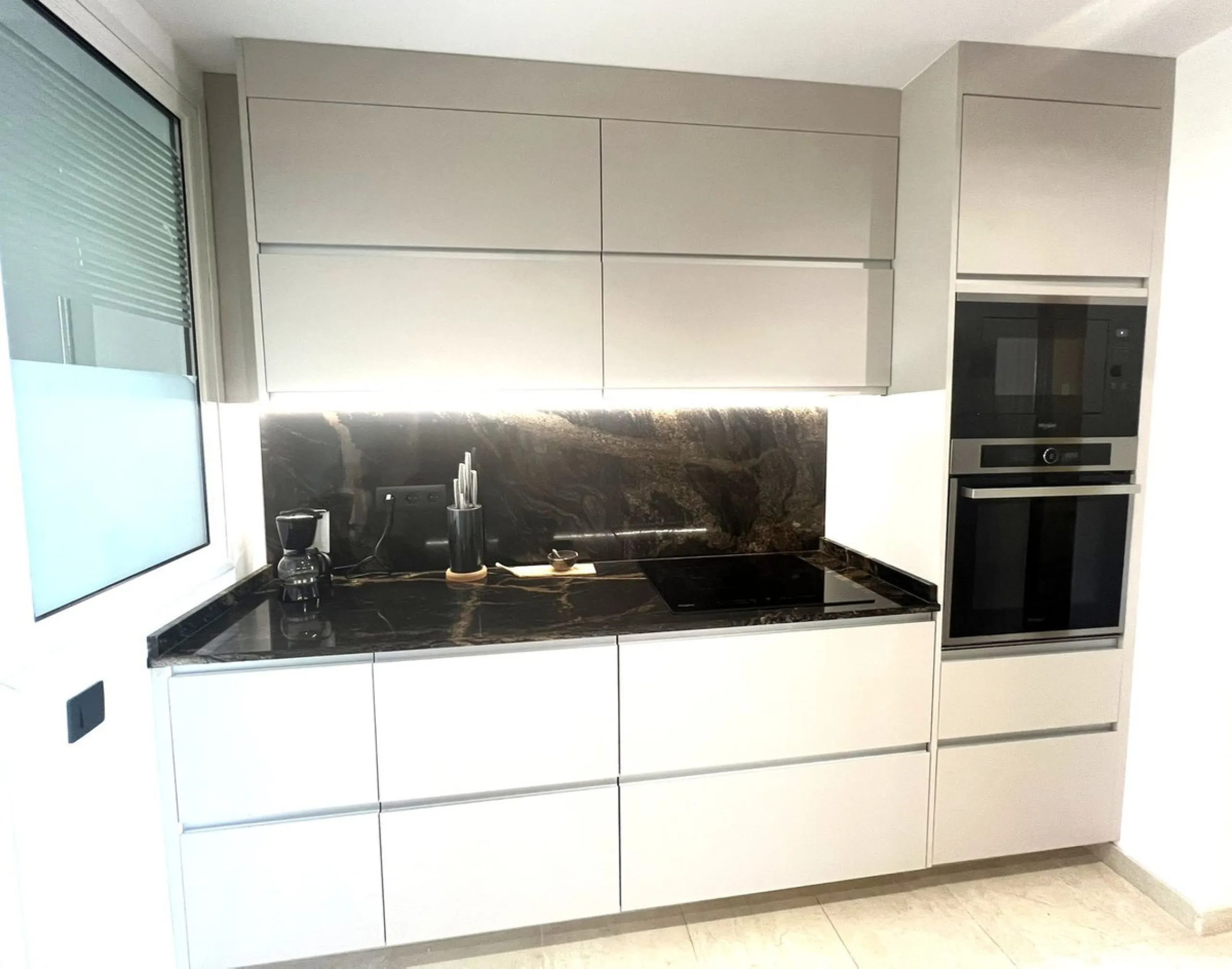 Discover this exceptional first-floor corner apartment, where modern comfort meets breathtaking scenery. Boasting two expansive, glassed in terraces, the residence offers panoramic views that stretch from the sparkling Mediterranean Sea to the majestic su