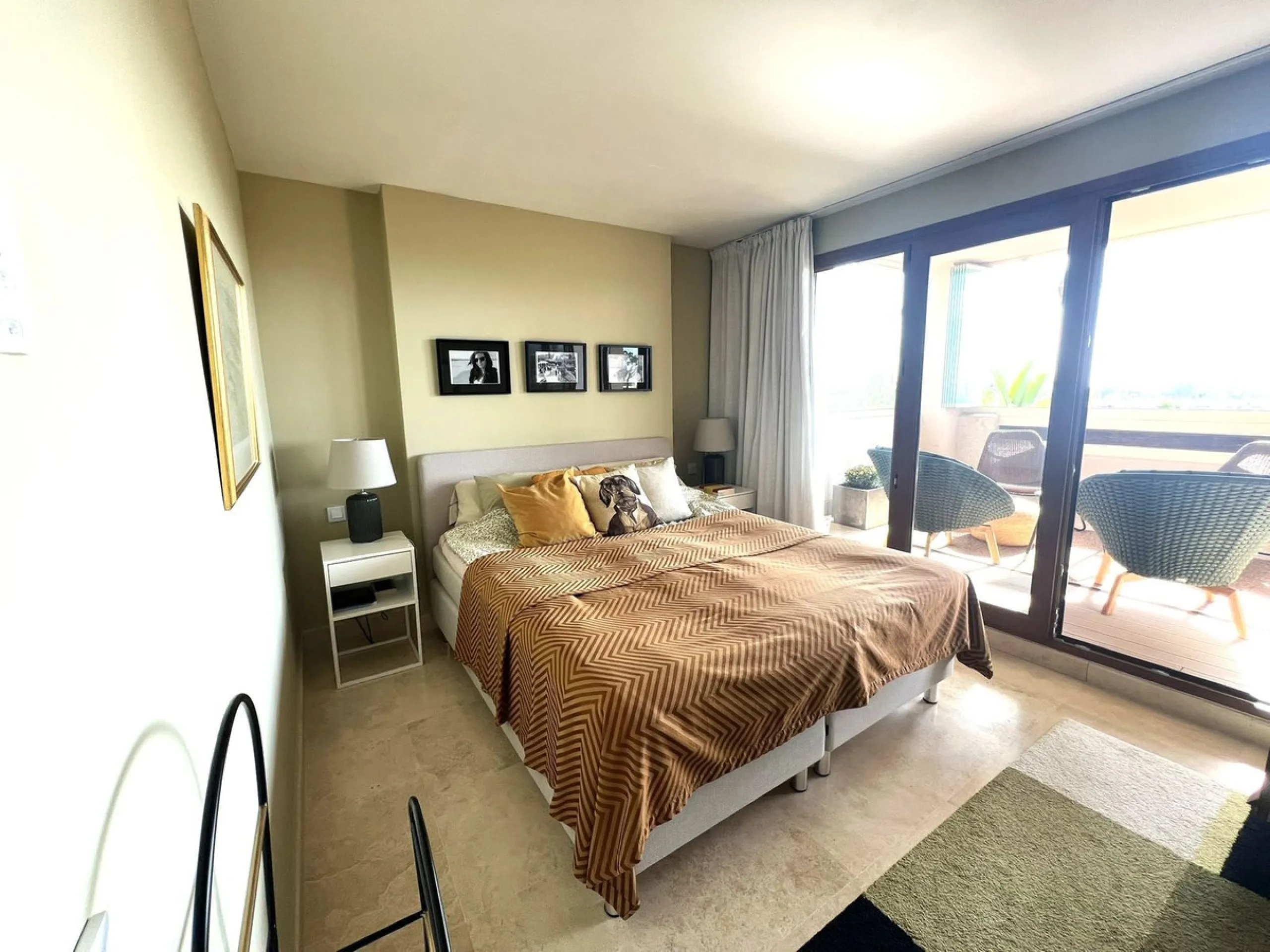 Discover this exceptional first-floor corner apartment, where modern comfort meets breathtaking scenery. Boasting two expansive, glassed in terraces, the residence offers panoramic views that stretch from the sparkling Mediterranean Sea to the majestic su