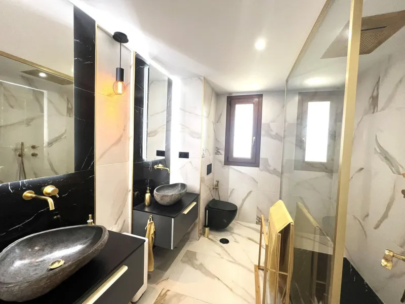 Discover this exceptional first-floor corner apartment, where modern comfort meets breathtaking scenery. Boasting two expansive, glassed in terraces, the residence offers panoramic views that stretch from the sparkling Mediterranean Sea to the majestic su