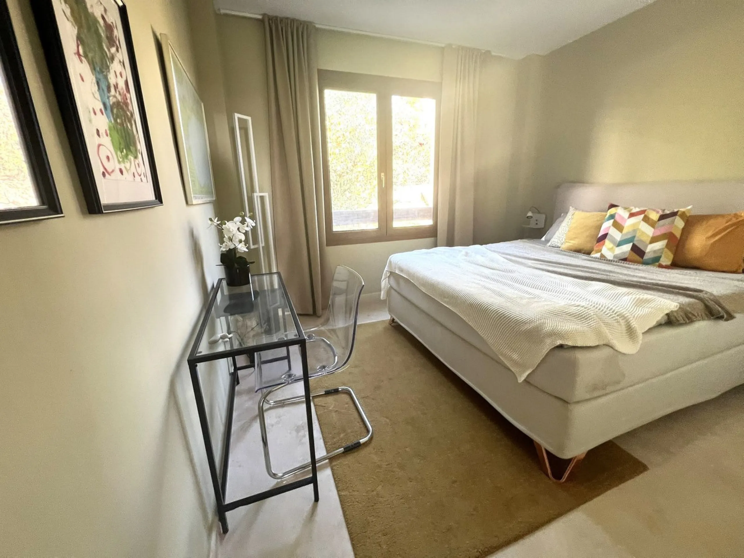 Discover this exceptional first-floor corner apartment, where modern comfort meets breathtaking scenery. Boasting two expansive, glassed in terraces, the residence offers panoramic views that stretch from the sparkling Mediterranean Sea to the majestic su