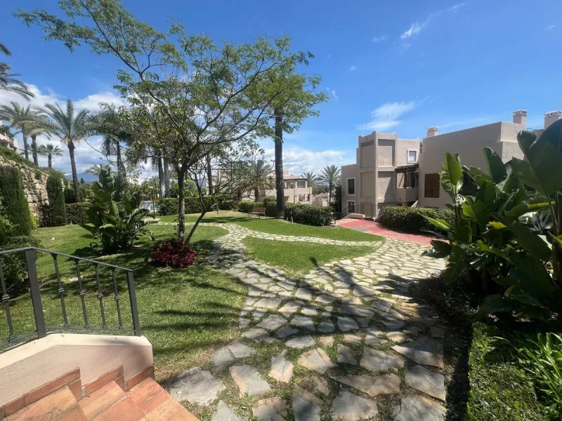 Discover this exceptional first-floor corner apartment, where modern comfort meets breathtaking scenery. Boasting two expansive, glassed in terraces, the residence offers panoramic views that stretch from the sparkling Mediterranean Sea to the majestic su