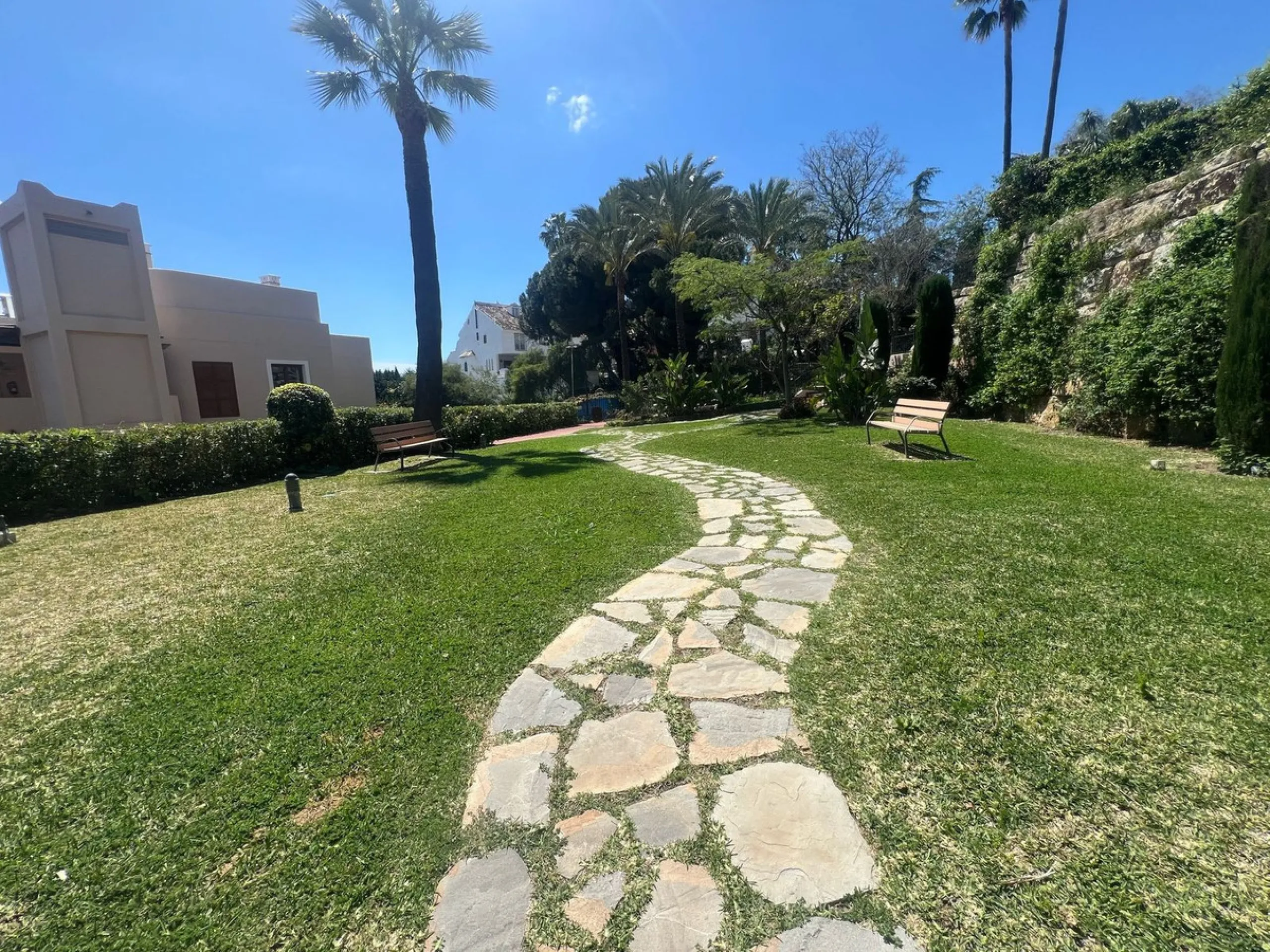 Discover this exceptional first-floor corner apartment, where modern comfort meets breathtaking scenery. Boasting two expansive, glassed in terraces, the residence offers panoramic views that stretch from the sparkling Mediterranean Sea to the majestic su