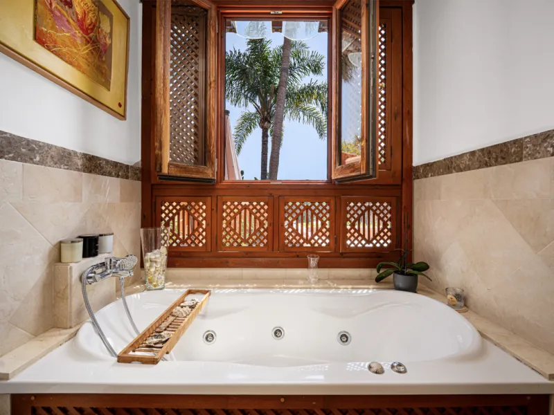 Townhouse Oasis is a five-bedroom luxury home in one of Marbella's most prestigious gated communities on the Golden Mile. Surrounded by tropical gardens, this townhouse offers privacy, comfort, and Mediterranean charm. With multiple terraces, a private ga