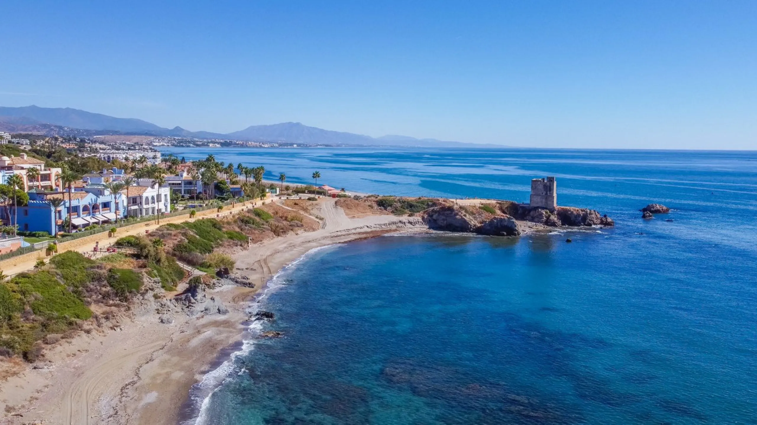 Stunning mid-floor apartment in the first line of the beach, with spectacular views of the sea, the beach, Gibraltar, and Africa, located in the exclusive Bay of Casares next to a protected historic area with an ancient Arab tower, within the prestigious 