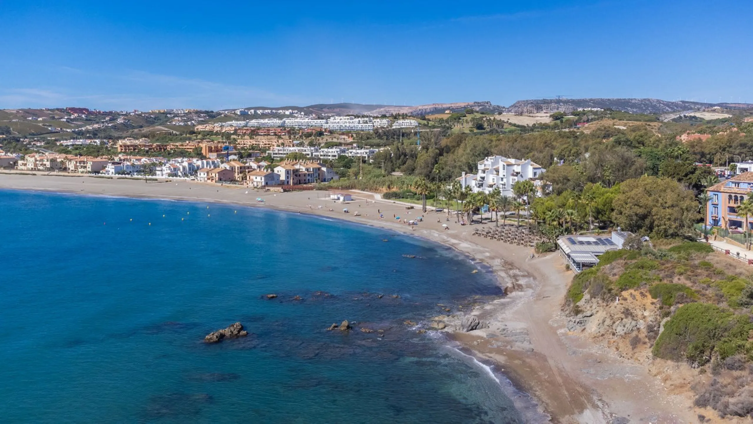 Stunning mid-floor apartment in the first line of the beach, with spectacular views of the sea, the beach, Gibraltar, and Africa, located in the exclusive Bay of Casares next to a protected historic area with an ancient Arab tower, within the prestigious 