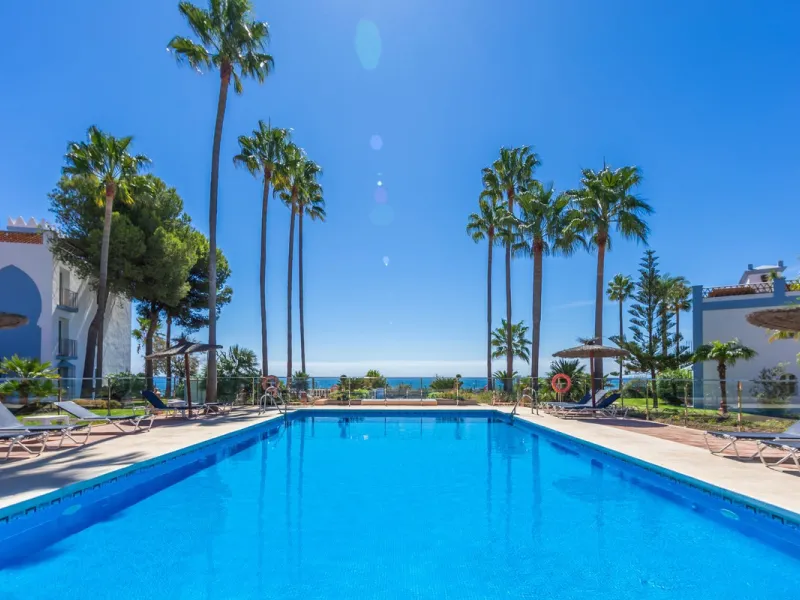 Stunning mid-floor apartment in the first line of the beach, with spectacular views of the sea, the beach, Gibraltar, and Africa, located in the exclusive Bay of Casares next to a protected historic area with an ancient Arab tower, within the prestigious 
