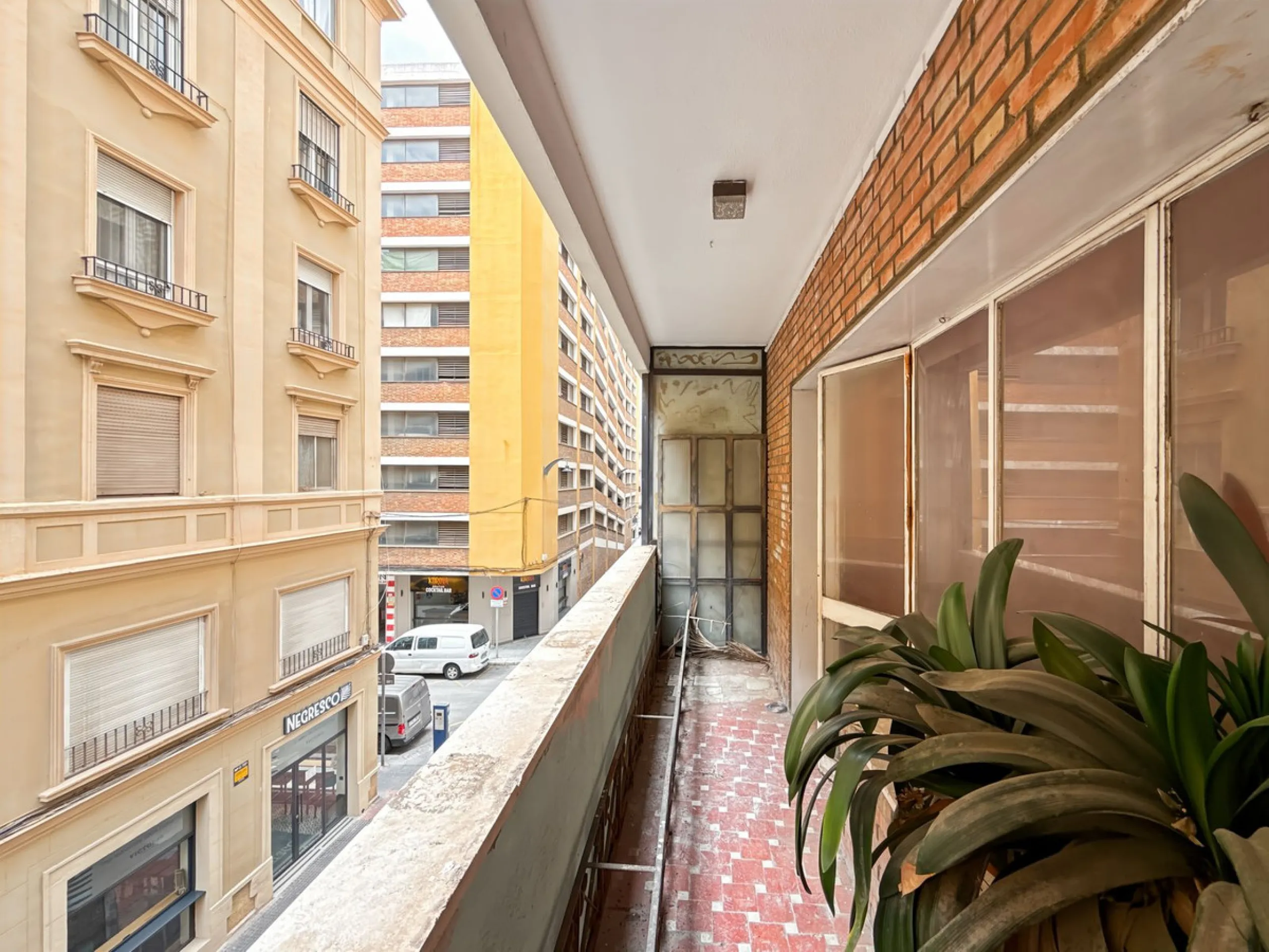 Some places can't be described by square meters or floor plans. They're described by how they make you feel the moment you walk in. This flat on Calle San Lorenzo, right in the beating heart of Málaga's Soho, has something rare — it has soul.