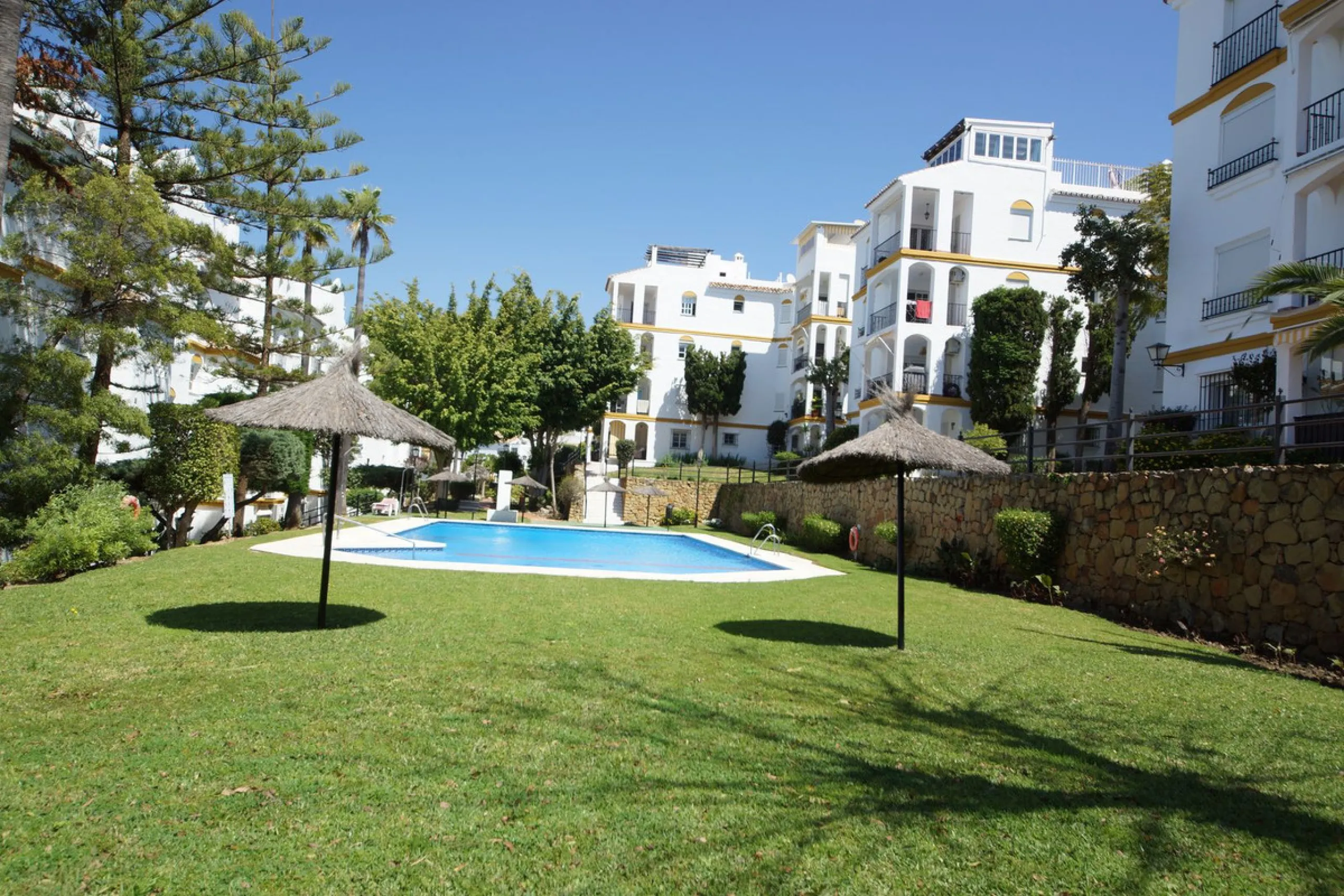 Spacious ground-floor apartment in a residential complex with a pool.