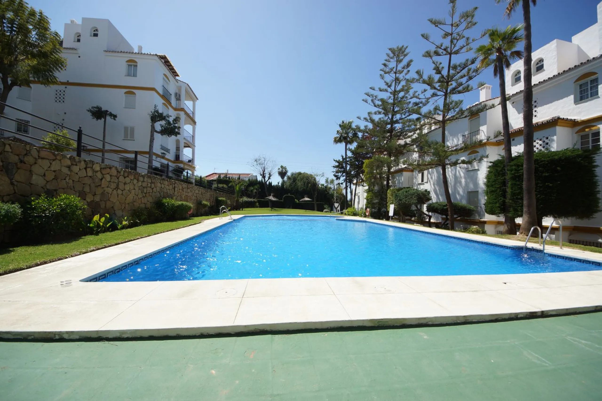 Spacious ground-floor apartment in a residential complex with a pool.