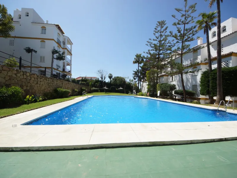 Spacious ground-floor apartment in a residential complex with a pool.