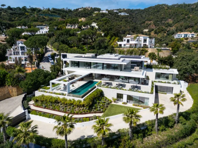 Discover this exceptional contemporary villa for sale in the prestigious gated community of El Madroñal, nestled in the tranquil hills of Marbella. This remarkable property seamlessly blends modern architectural design with natural beauty, offering breath