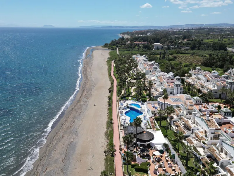 Discover seaside serenity in Estepona's ever popular complex - Dominion Beach located on the New Golden Mile. This spacious 2-bedroom, 2-bathroom apartment puts you just steps from the sand, with no road noise to disrupt the tranquility. The apartment is 