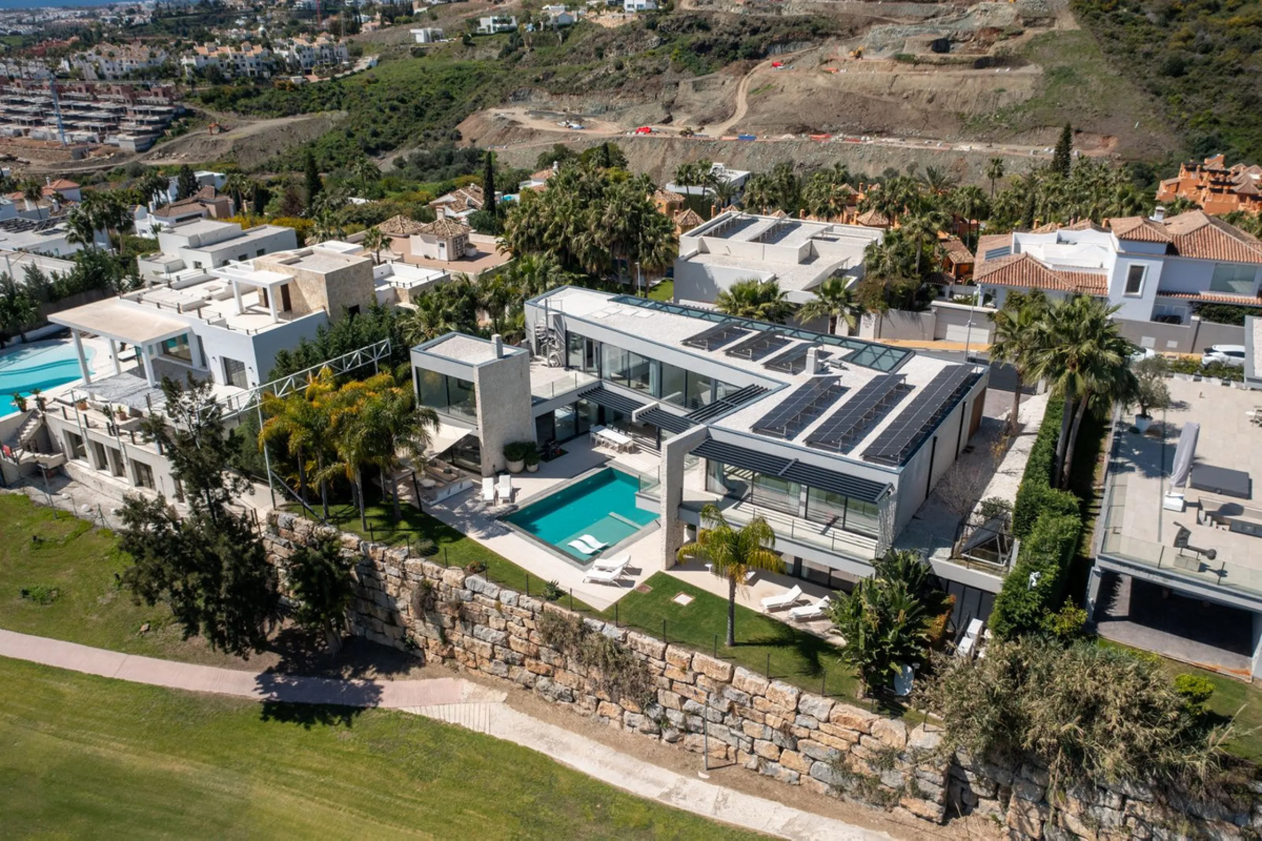 Newly built contemporary villa situated in the prestigious urbanization of La Alquería, Benahavís. Positioned frontline golf and facing east to south, the property offers panoramic views of the Mediterranean Sea, the coastline, and the iconic La Concha mo