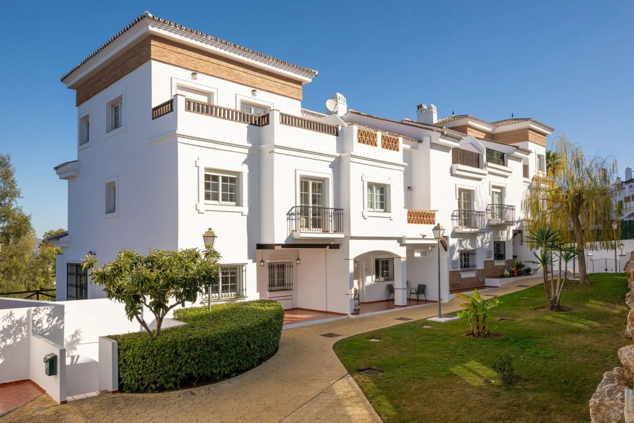 Townhouse for sale in Lauro Golf one of the most prestigious golf courses in Malaga. The property is distributed over three floors. On the ground floor there is a fully equipped kitchen, a toilet, a large living room with a fireplace that leads to a priva